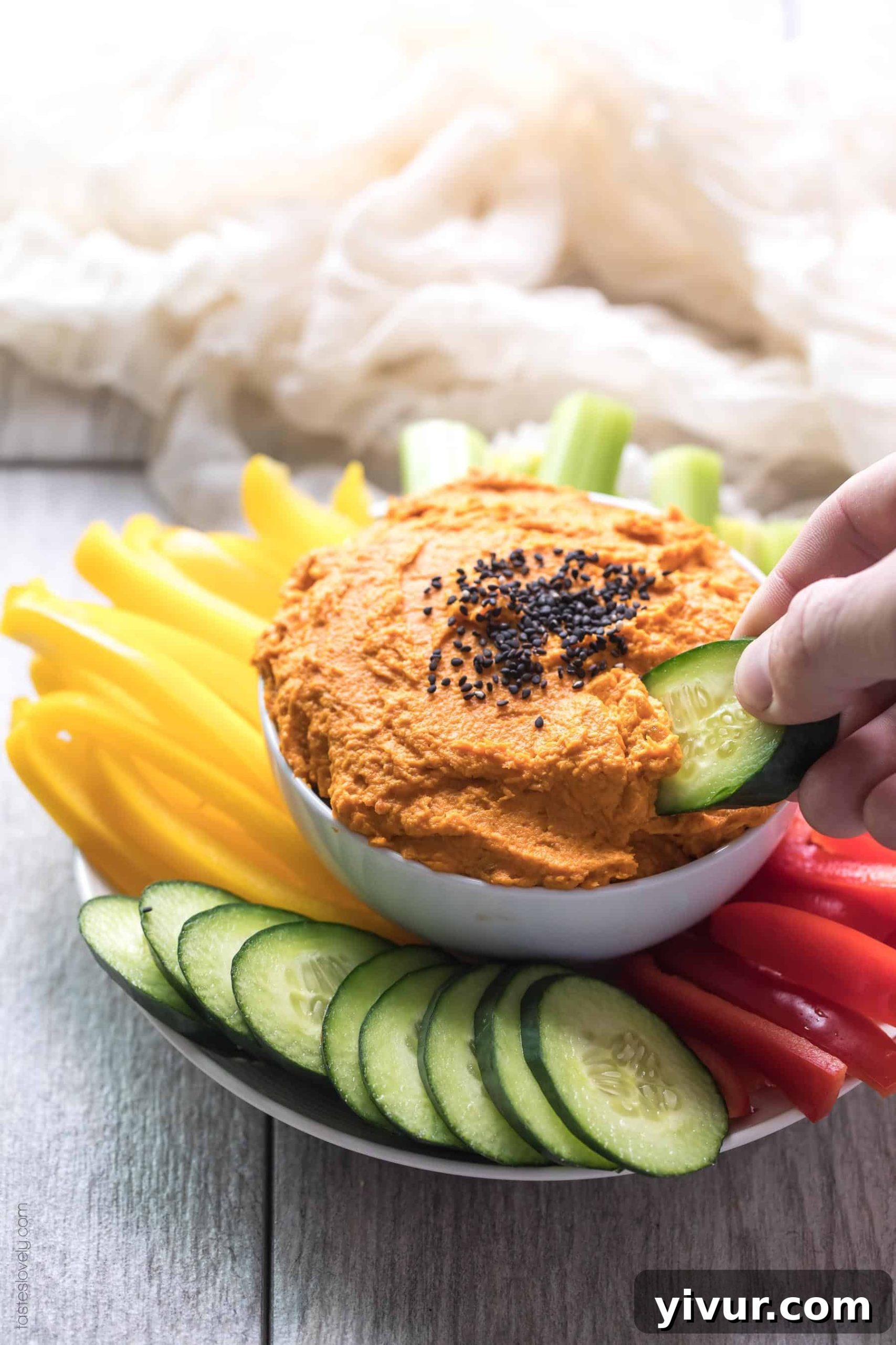 Delicious Paleo and Whole30 roasted carrot dip served with fresh vegetables