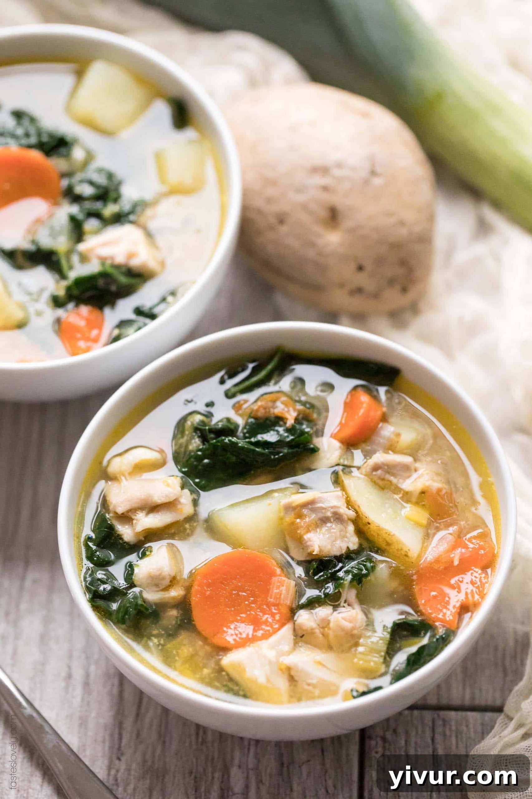 Wholesome Chicken and Kale Potato and Leek Soup 5 An inviting overhead shot of two white bowls filled with hearty potato and leek soup, showcasing the vibrant ingredients.