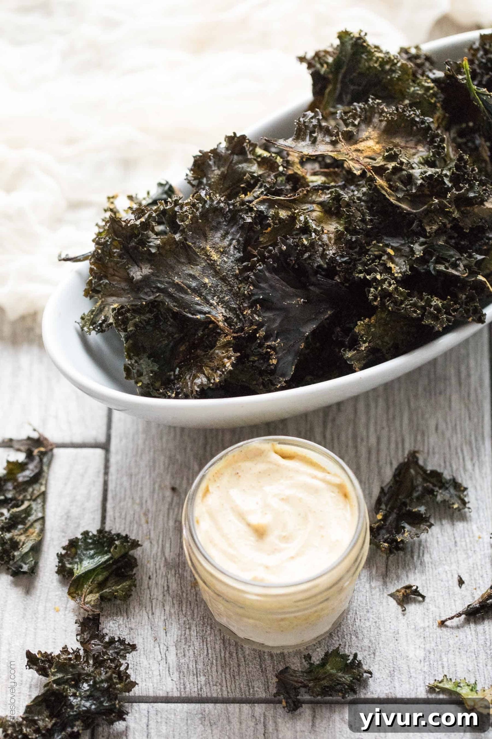 Roasted Kale Chips with Curry Aioli - a crispy, crunchy salty snack that is Paleo & Whole30. Ready in 20 minutes. Served with a curry aioli dipping sauce.