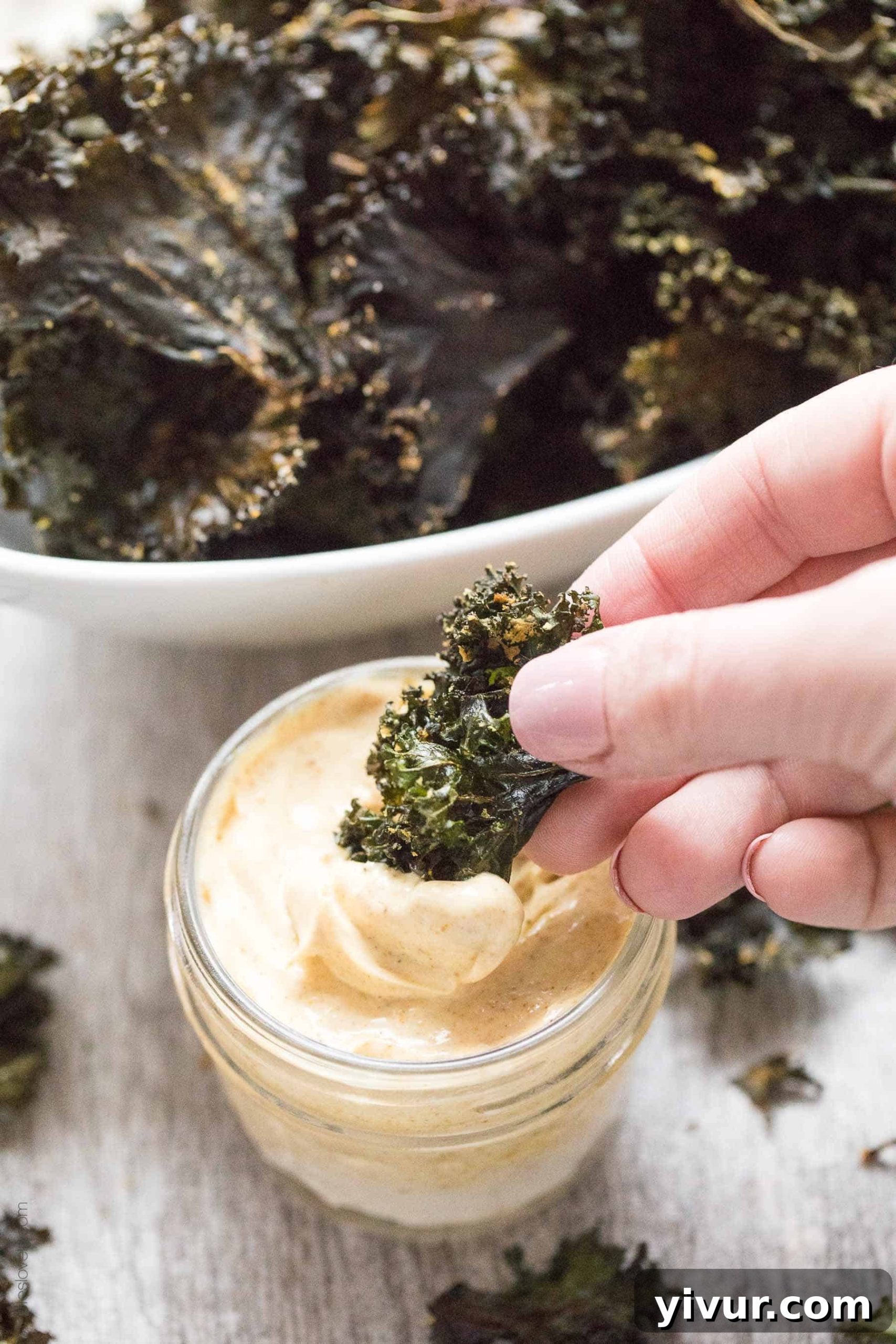 Roasted Kale Chips with Curry Aioli - a crispy, crunchy salty snack that is Paleo & Whole30. Ready in 20 minutes. Served with a curry aioli dipping sauce.