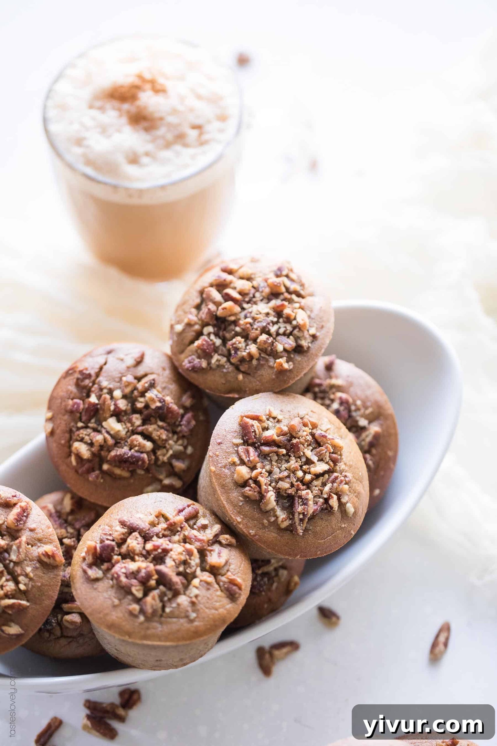 A cozy scene featuring Paleo Chai Spice Banana Muffins in a bowl, with a steaming chai latte in the background, inviting you to enjoy a perfect pairing.