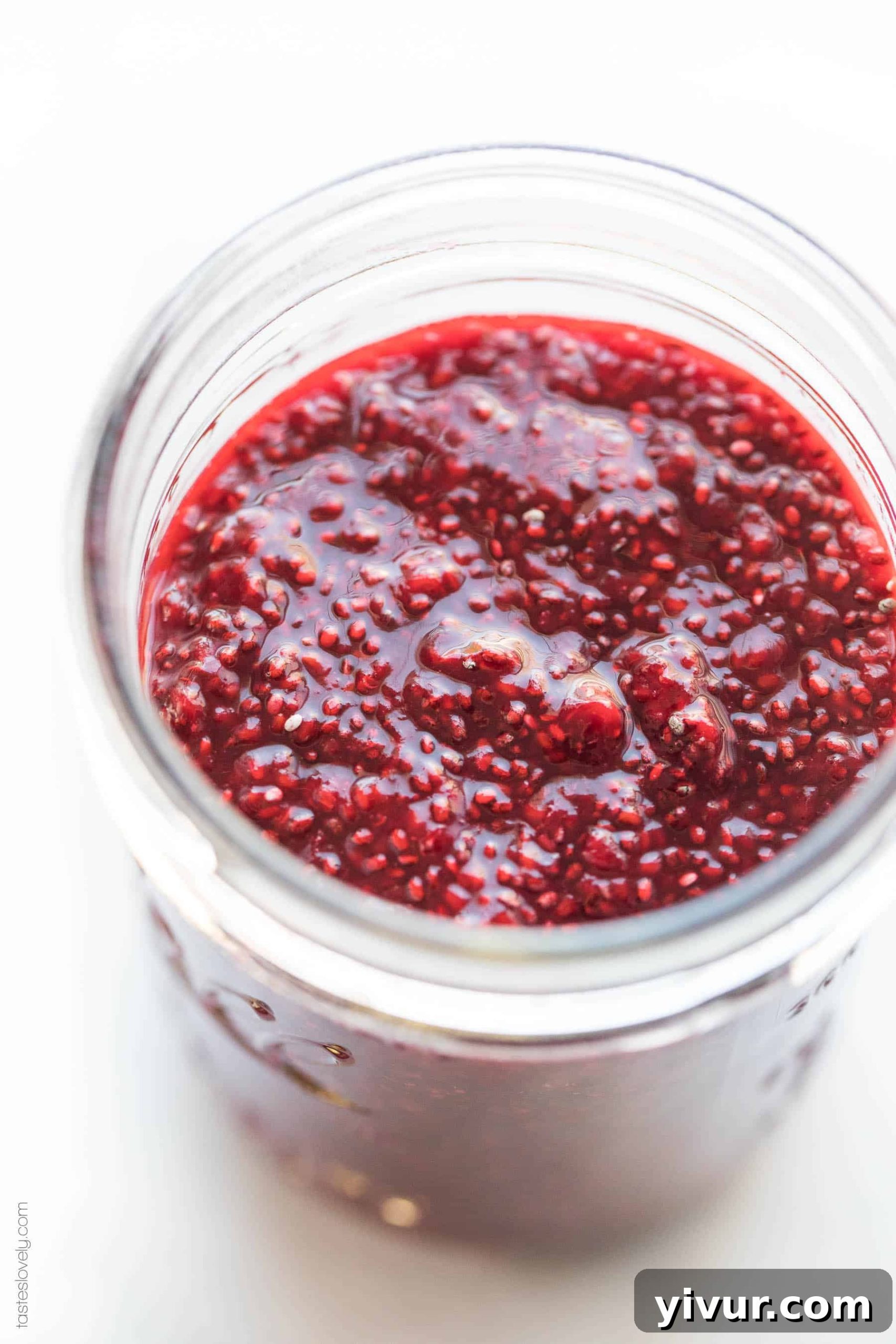 Close-up of freshly made Paleo Chia Seed Jam with frozen berries, showing its thick texture and vibrant color, sweetened with natural coconut sugar.