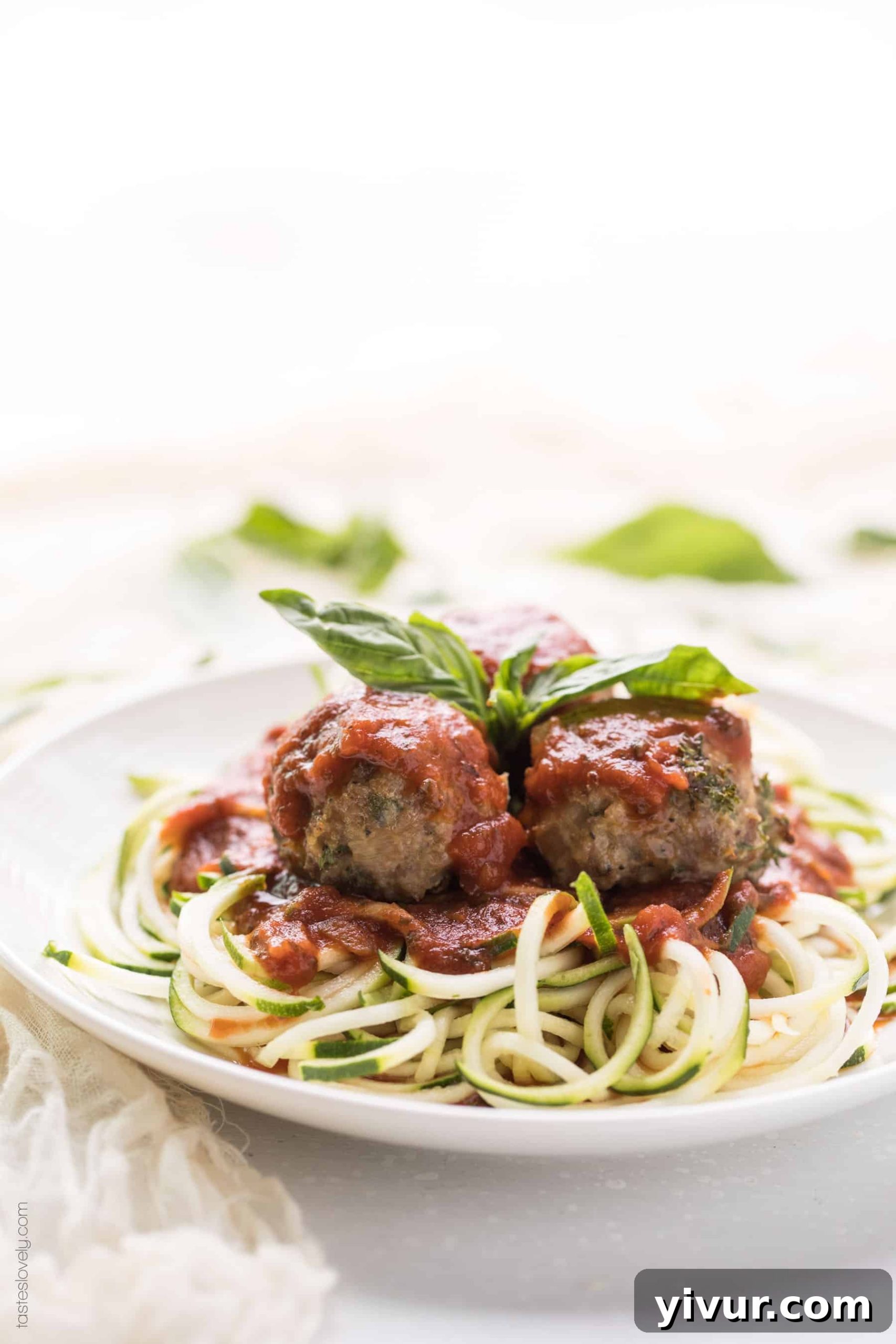 keto meatballs recipe on a plate with sauce and zucchini noodles