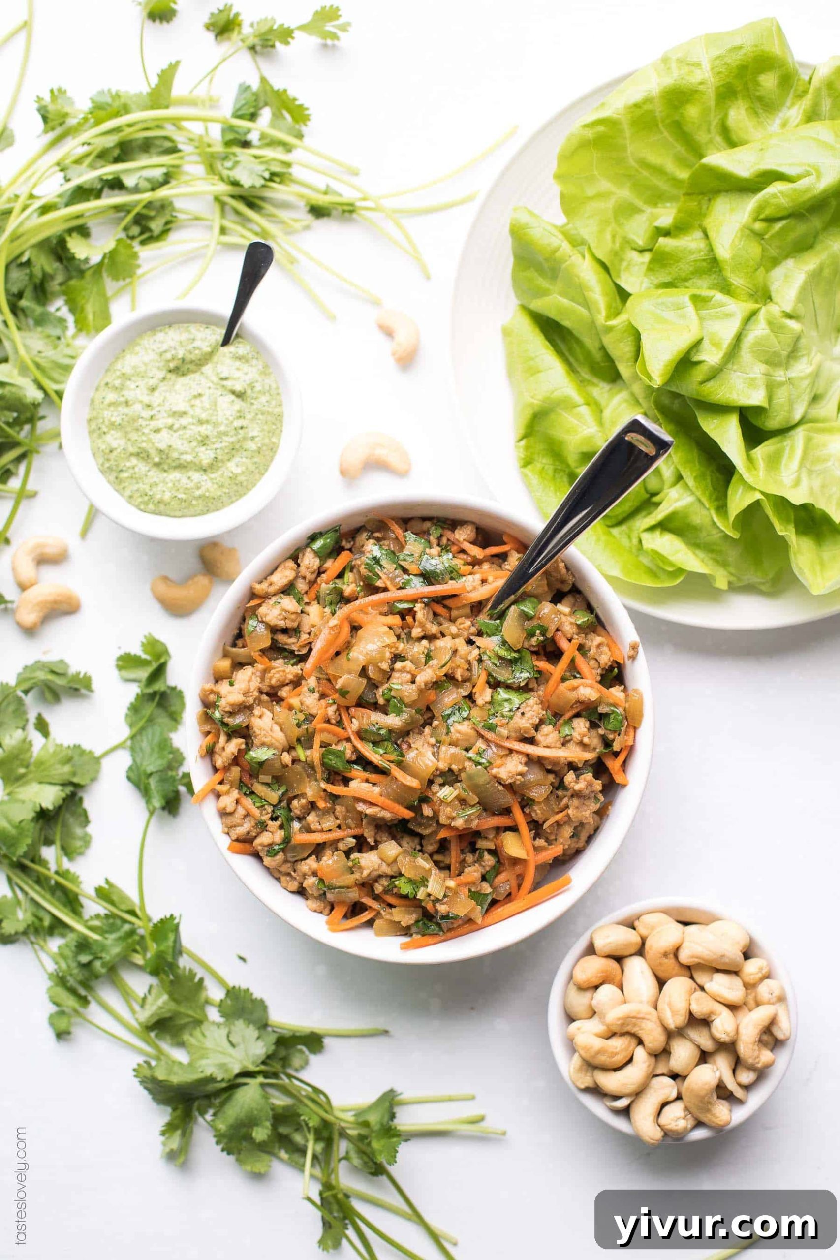 Whole30 Keto Thai Chicken Lettuce Wraps - a quick and healthy dinner recipe with ground chicken, sauteed onions, a thai sauce, cilantro and shredded carrots. Topped with a bright and fresh herby green dressing and cashews. Paleo, low carb, gluten free, grain free, dairy free, sugar free, clean eating, real food.