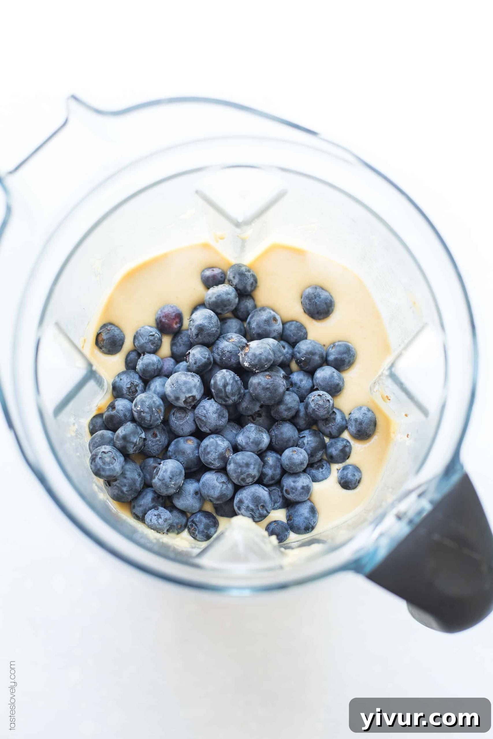 A selection of Paleo Blueberry Muffins, showcasing their airy texture and vibrant blueberry pockets.