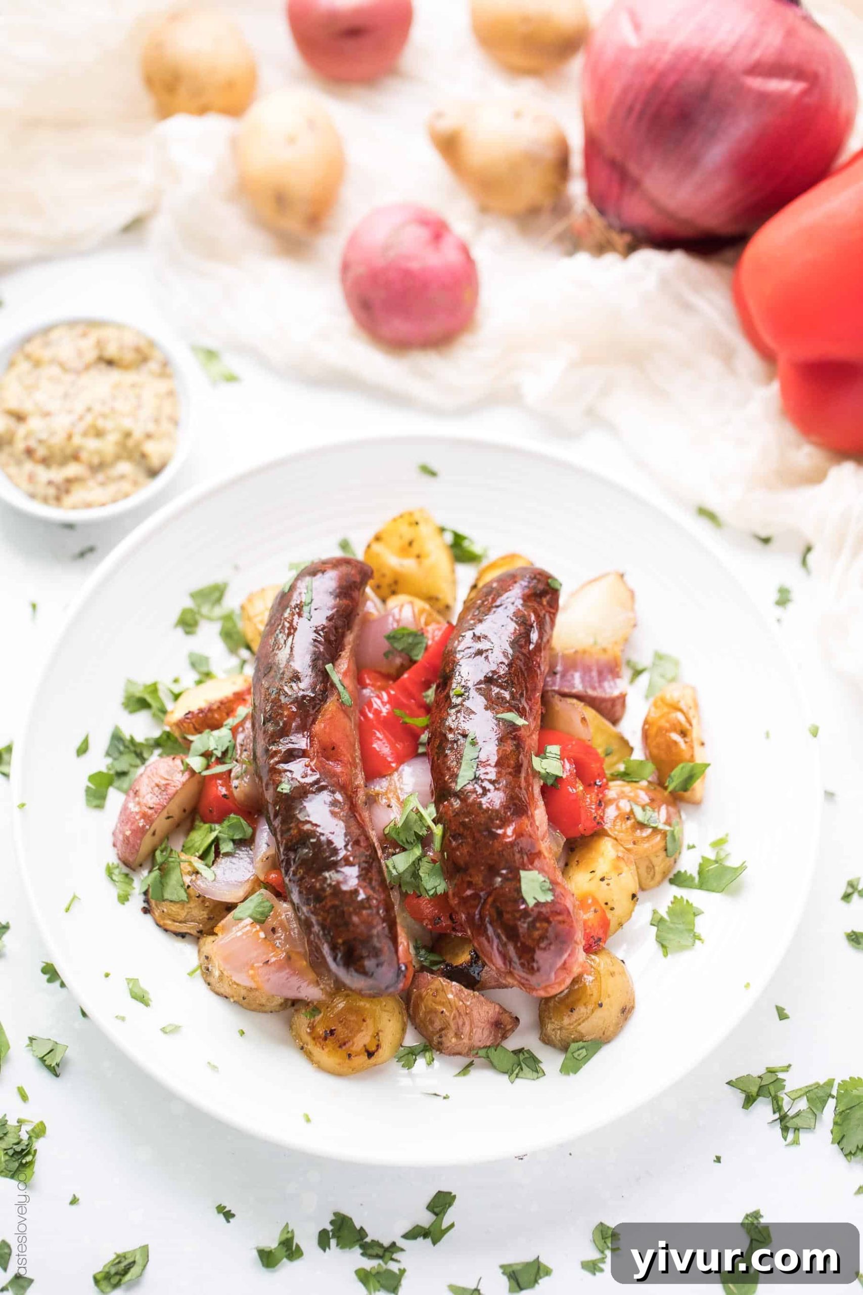 Easy Paleo and Whole30 Sheet Pan Sausage, Bell Pepper and Potato Roast. Quick and healthy breakfast or dinner recipe with only 10 minutes of prep. Gluten-free, grain-free, dairy-free, sugar-free, keto, clean eating, real food approved.