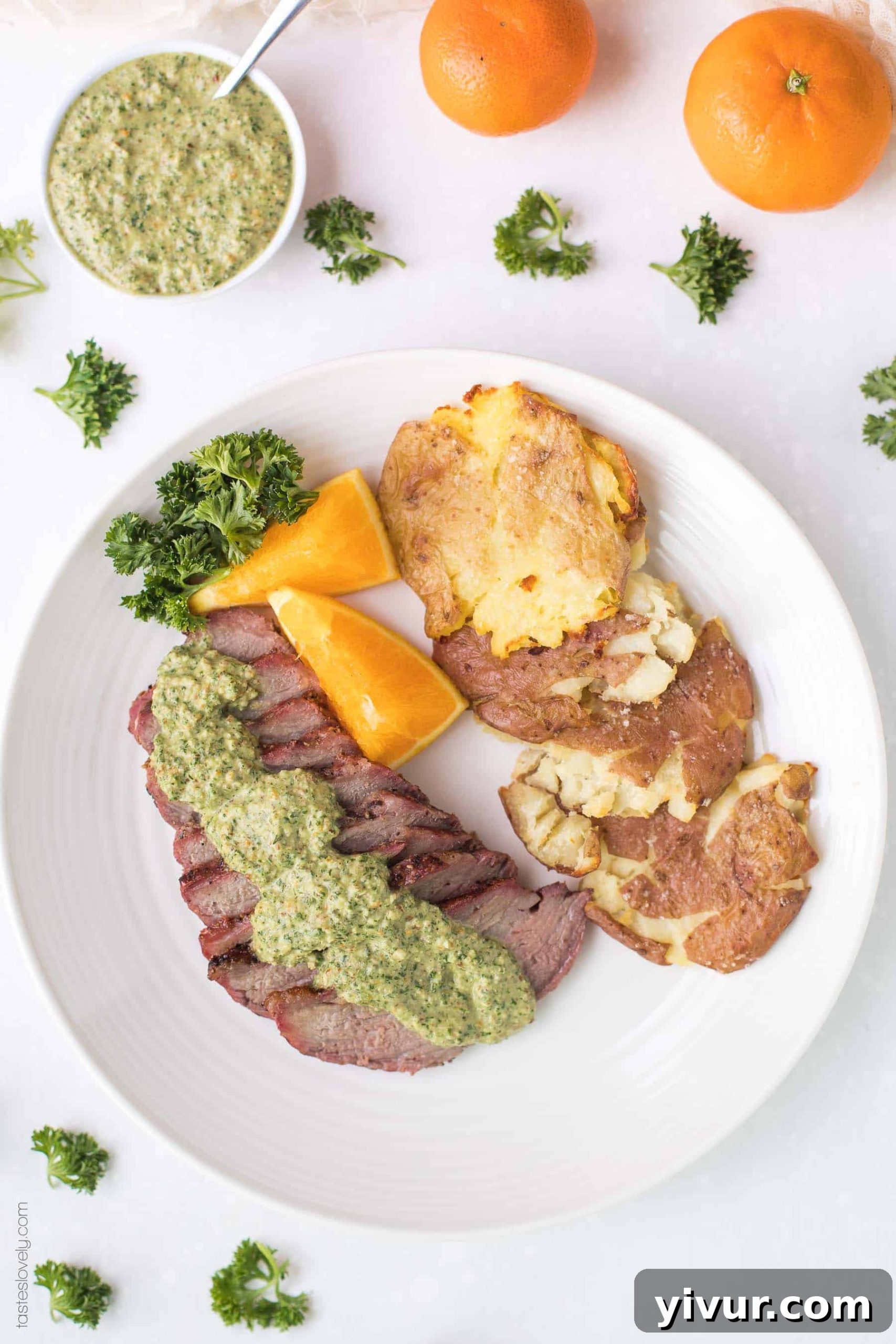 Whole30 Keto Tri Tip with Zesty Orange Parsley Sauce 5 Plated Whole30 Keto Tri Tip dinner with orange parsley sauce and a side of roasted vegetables, showcasing a complete and healthy meal.