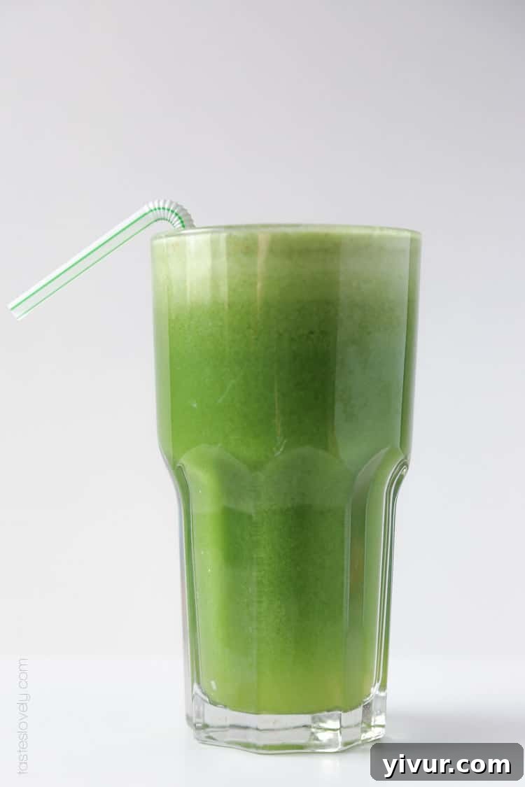 A full glass of vibrant green juice, symbolizing health and refreshment.