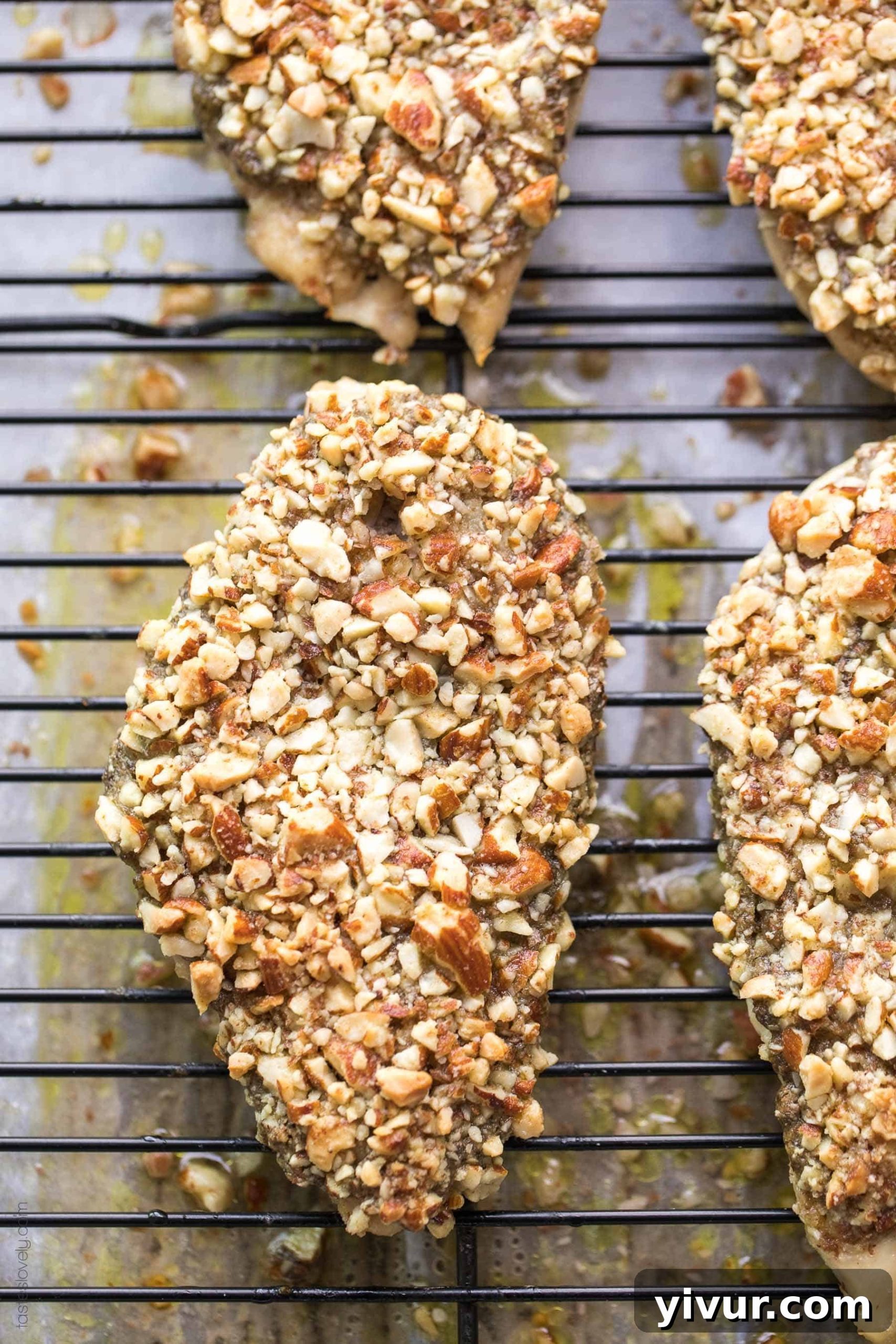 Almond-Crusted Pesto Chicken (Paleo & Whole30) 5 A raw chicken breast spread with pesto and topped with chopped raw almonds, ready for baking.