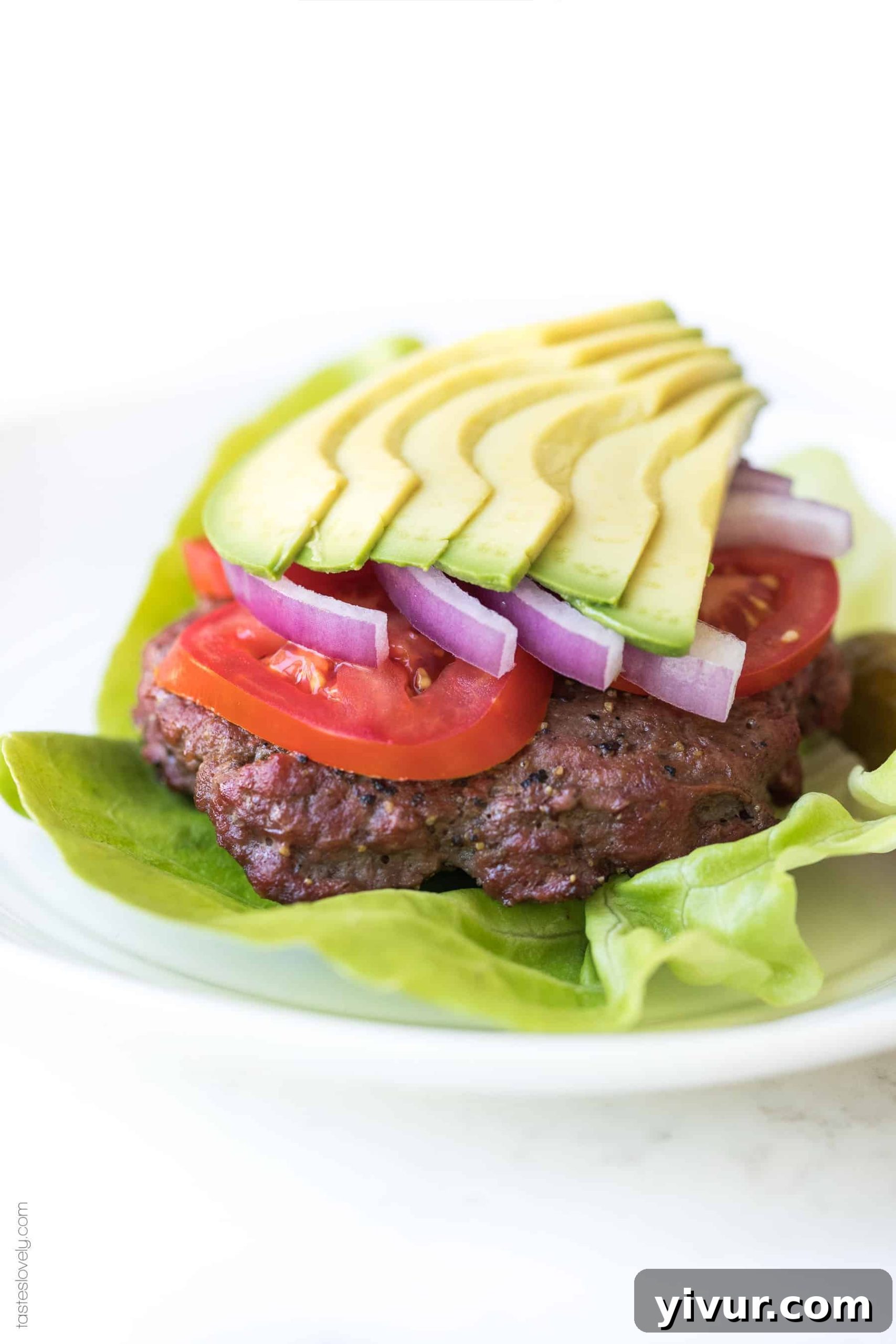 Close-up of freshly grilled keto burger patties, golden brown and perfectly seared, ready for toppings.