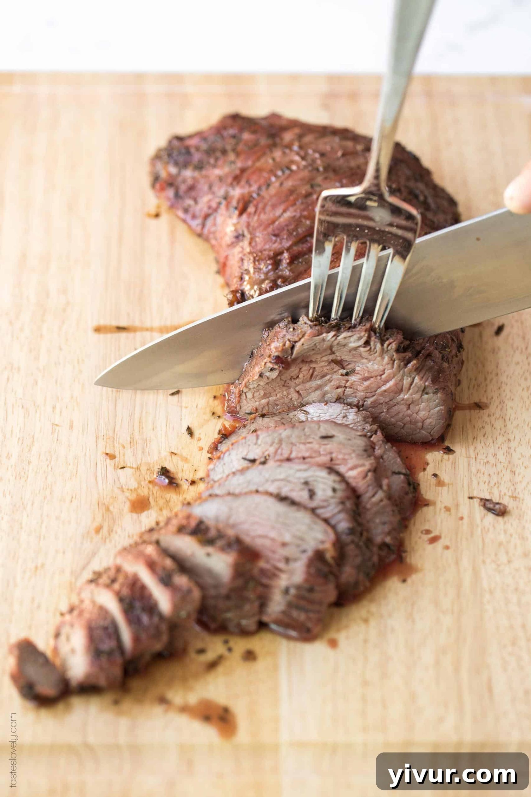 A sharp knife expertly slicing a perfectly cooked tri-tip roast against the grain into thin, juicy slices.