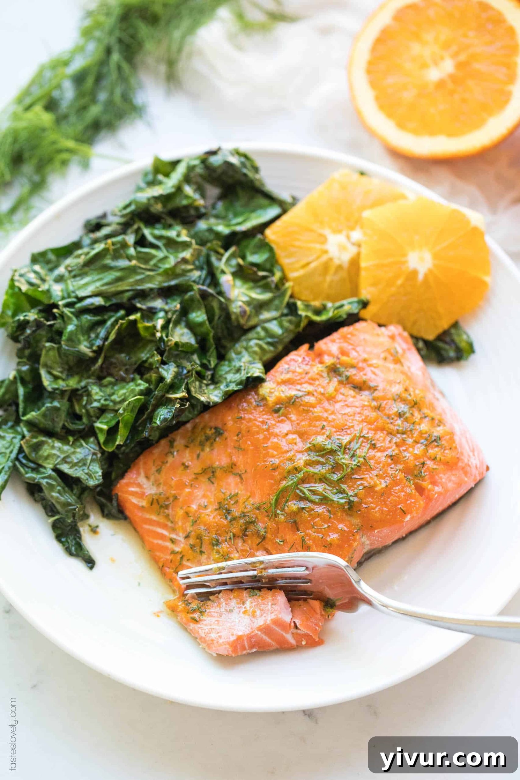 Vibrant Orange Dill Butter Salmon Whole30 Paleo Keto Friendly 6 Cooked salmon with orange dill butter, served with a side of green vegetables and orange wedges.
