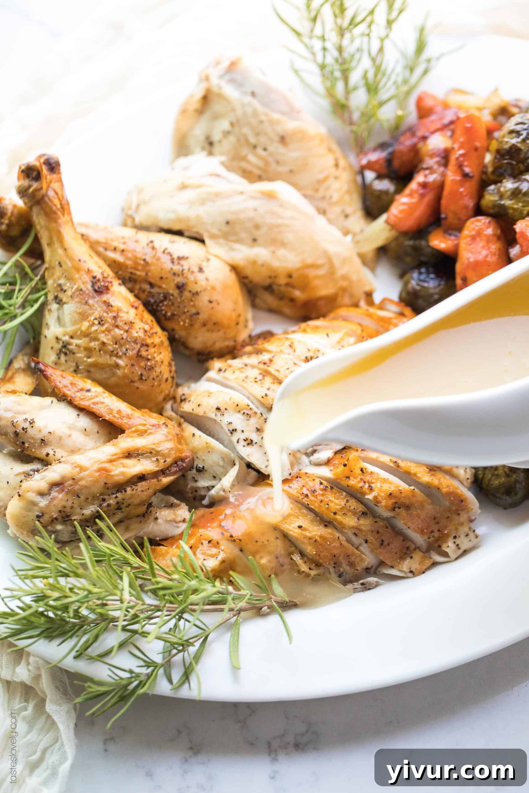 Gravy being poured over sliced roasted chicken breasts