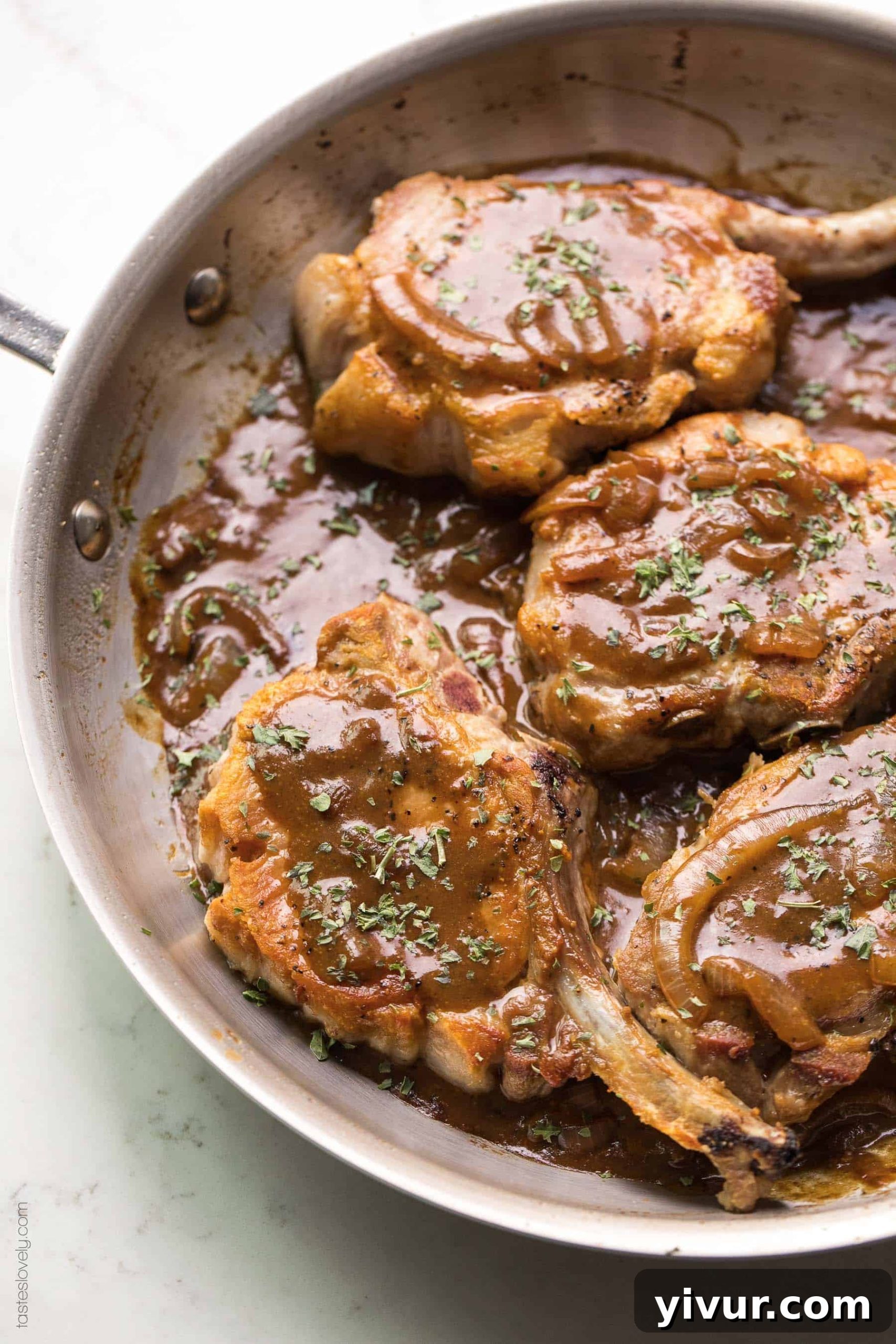Flavorful Balsamic Mustard Pork Chops Whole30 and Keto 2 Pork chops in a brown balsamic mustard sauce in a skillet