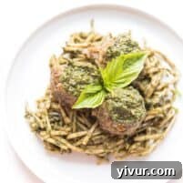 Pesto meatballs served on pesto hearts of palm low carb noodles