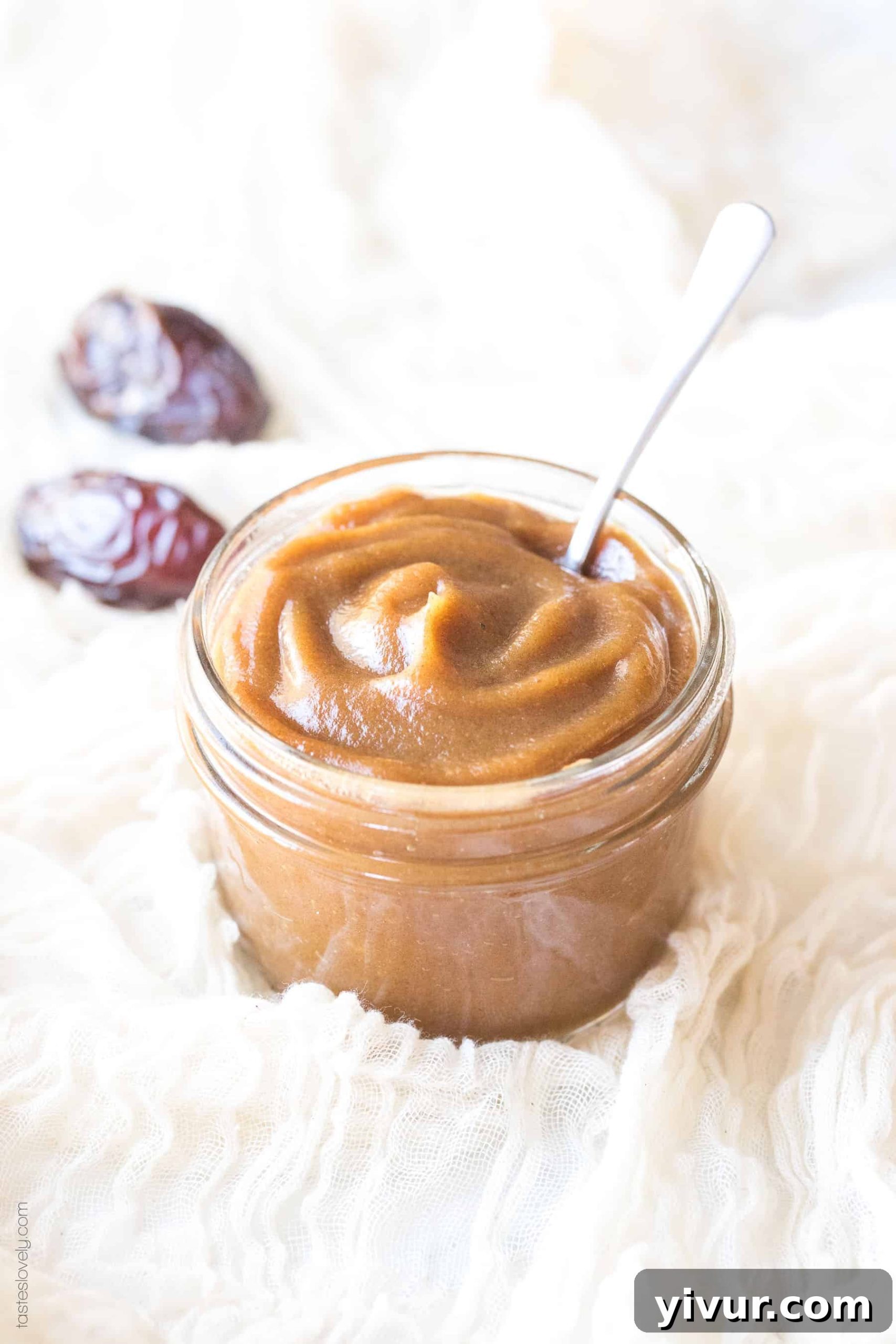 A close-up of a glass mason jar filled with smooth, natural date paste, a perfect refined sugar substitute for healthy living.