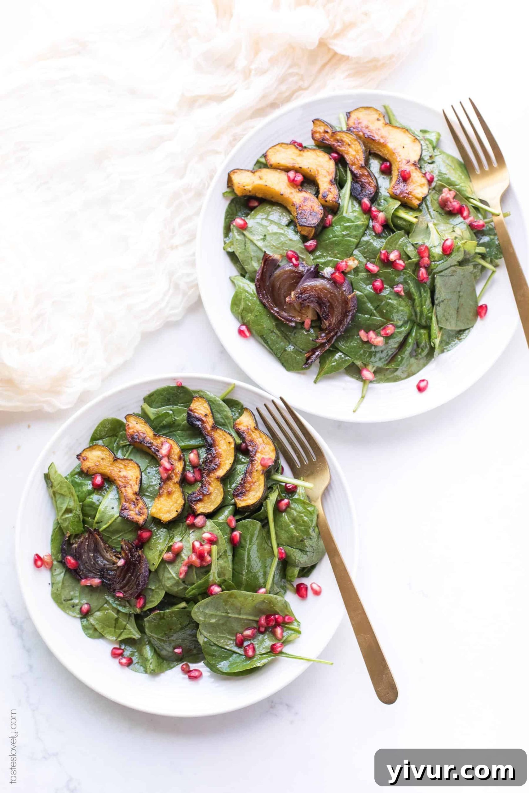 A close-up shot of the finished Paleo and Whole30 Roasted Acorn Squash Spinach Salad, showcasing its inviting autumn colors and fresh ingredients.