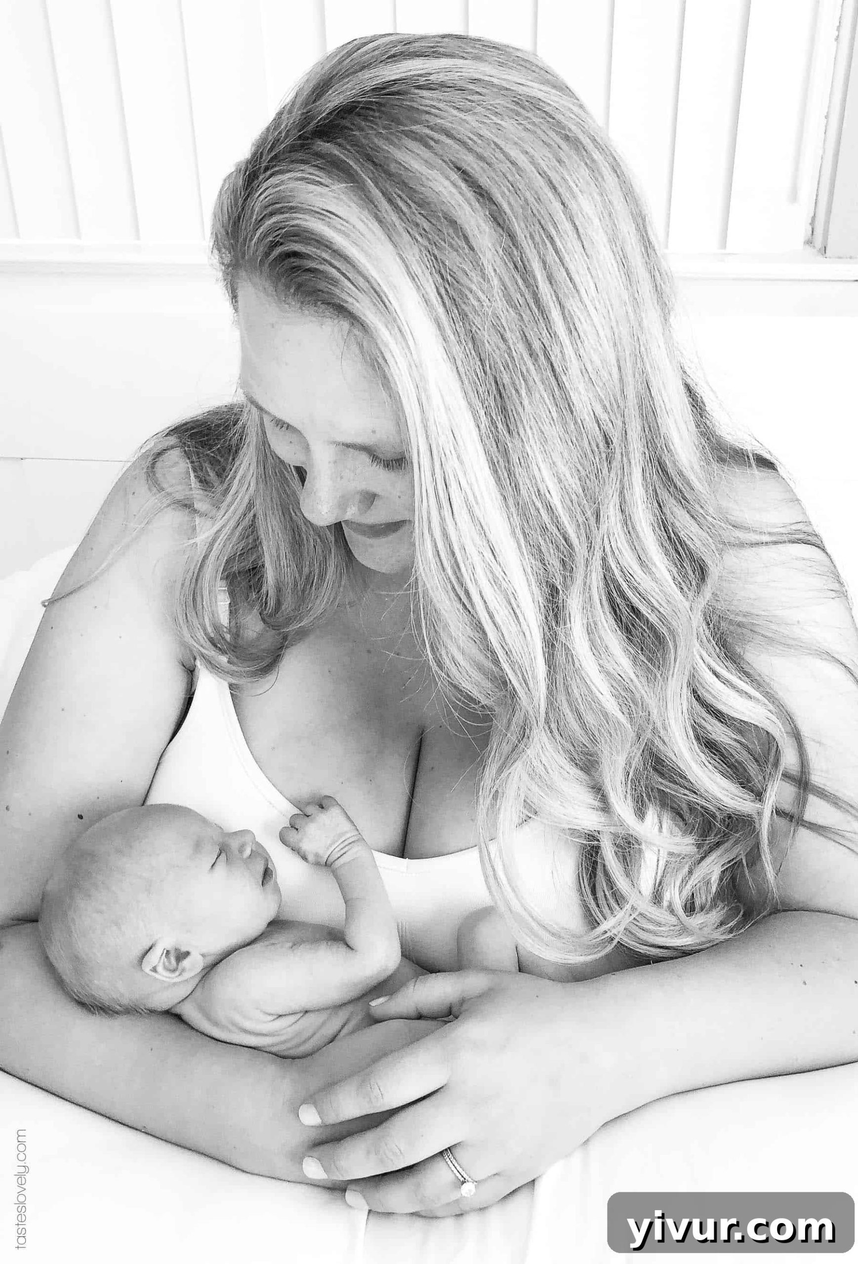 A mother holding her baby in a loving embrace, highlighting the bond of breastfeeding.