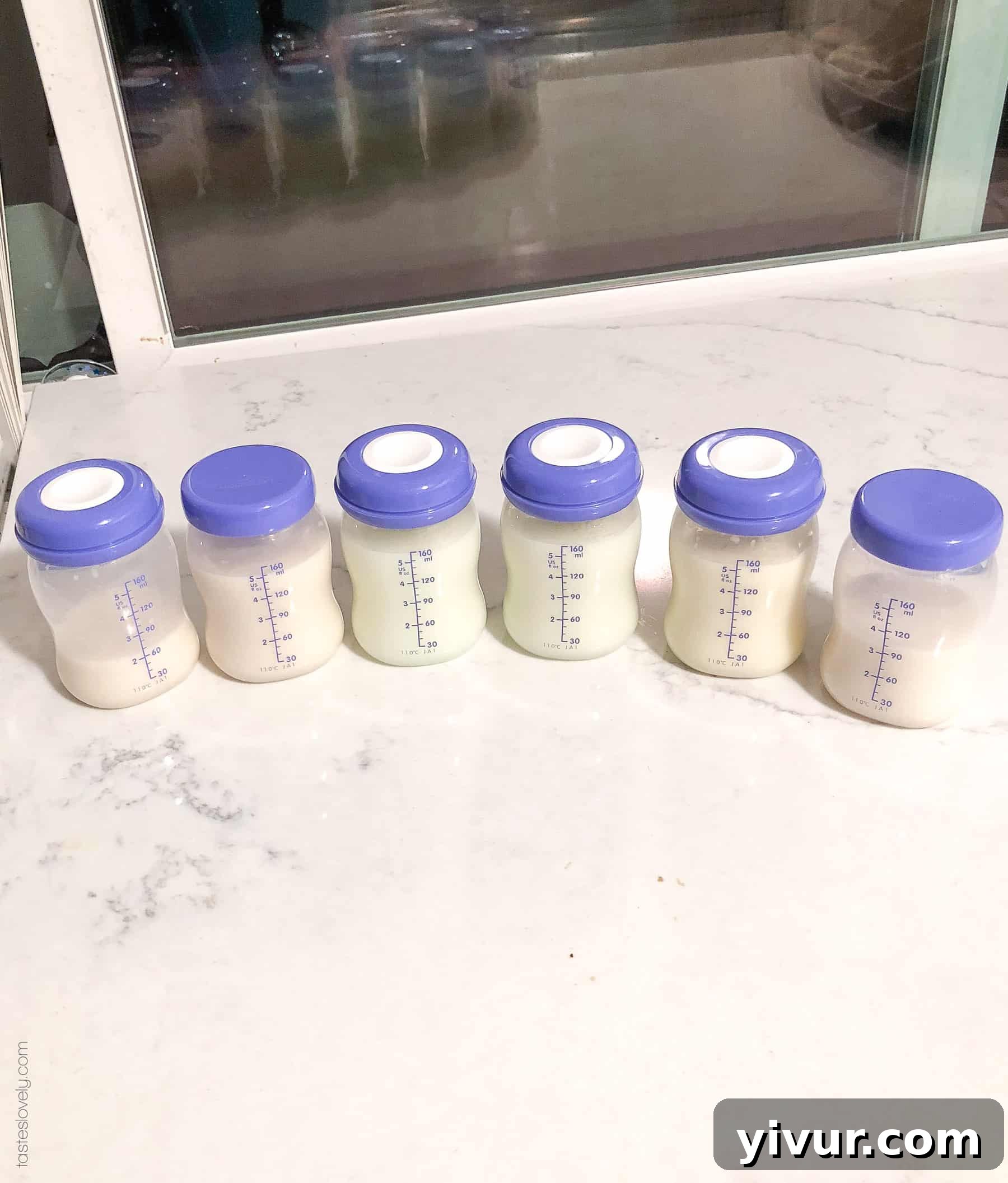Close-up of a breast pump collection showing a significant volume of pumped milk, illustrating a healthy milk supply.