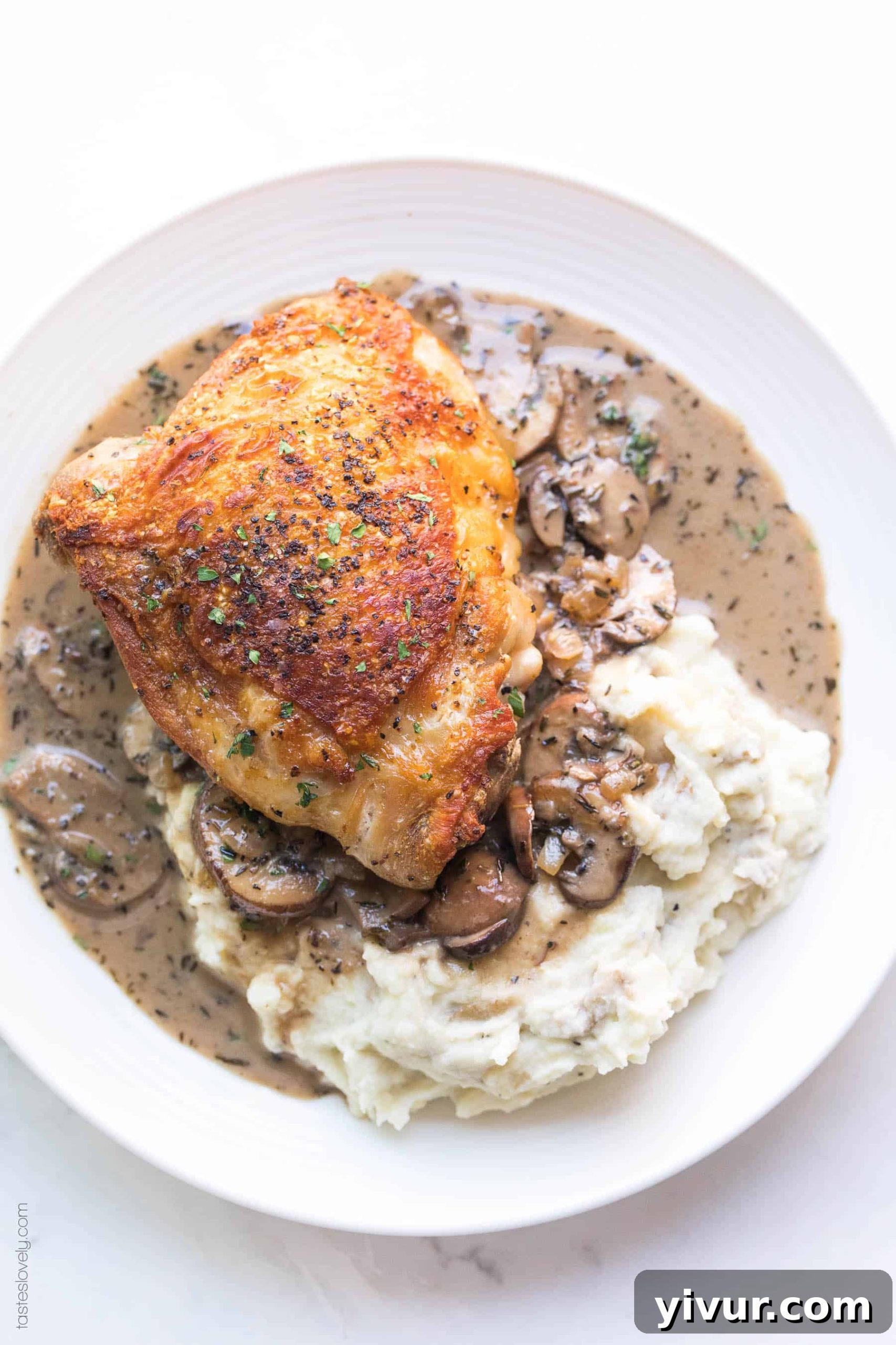 Luxurious Creamy Mushroom Chicken Thighs for Whole30 and Keto 2 Crispy chicken thighs on a plate with mashed potatoes and creamy mushroom sauce, highlighting its low-carb and Whole30 nature