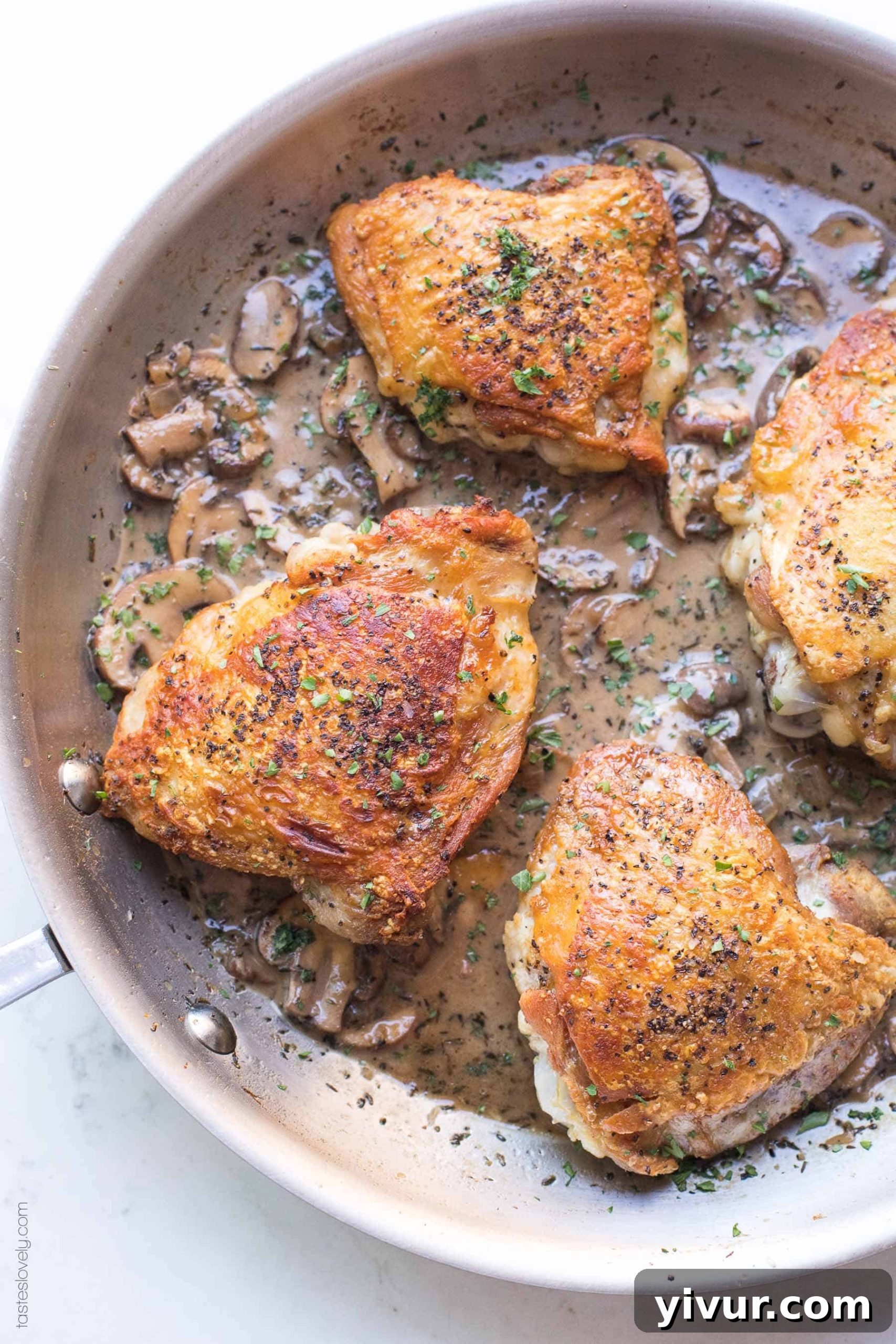 Luxurious Creamy Mushroom Chicken Thighs for Whole30 and Keto 3 Close-up of crispy chicken thighs in a skillet, showcasing the golden-brown skin with creamy mushroom sauce