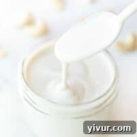 A small bowl of Cashew Cream, garnished with a sprinkle of herbs.