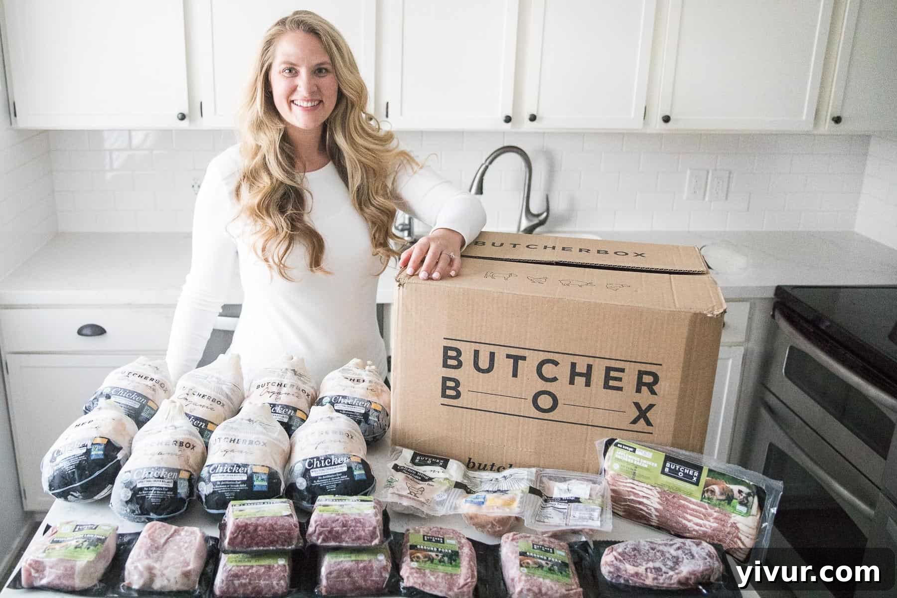 A smiling girl standing next to an open ButcherBox filled with frozen meat cuts, showcasing family-friendly convenience