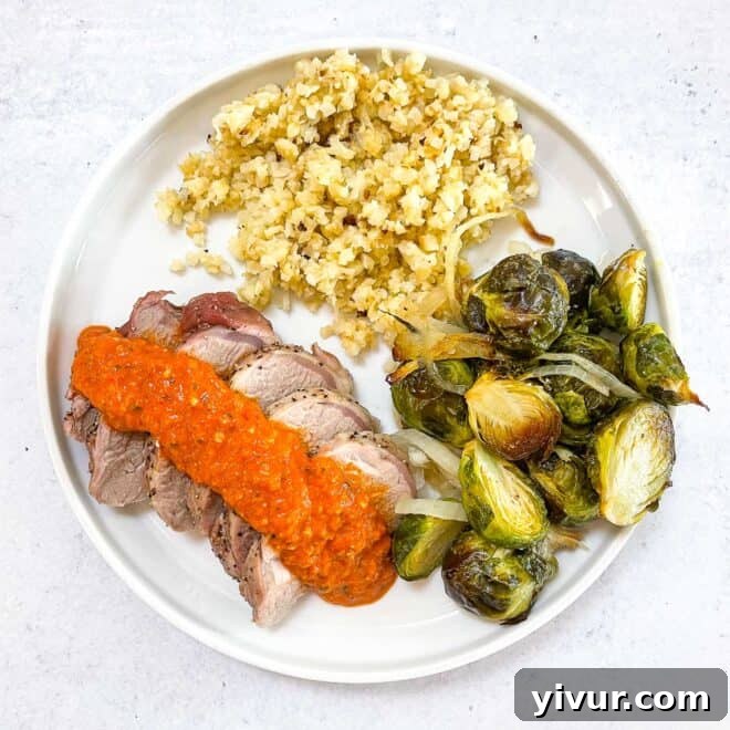 Keto sheet pan pork tenderloin with romesco sauce, Brussel sprouts, and hearts of palm rice