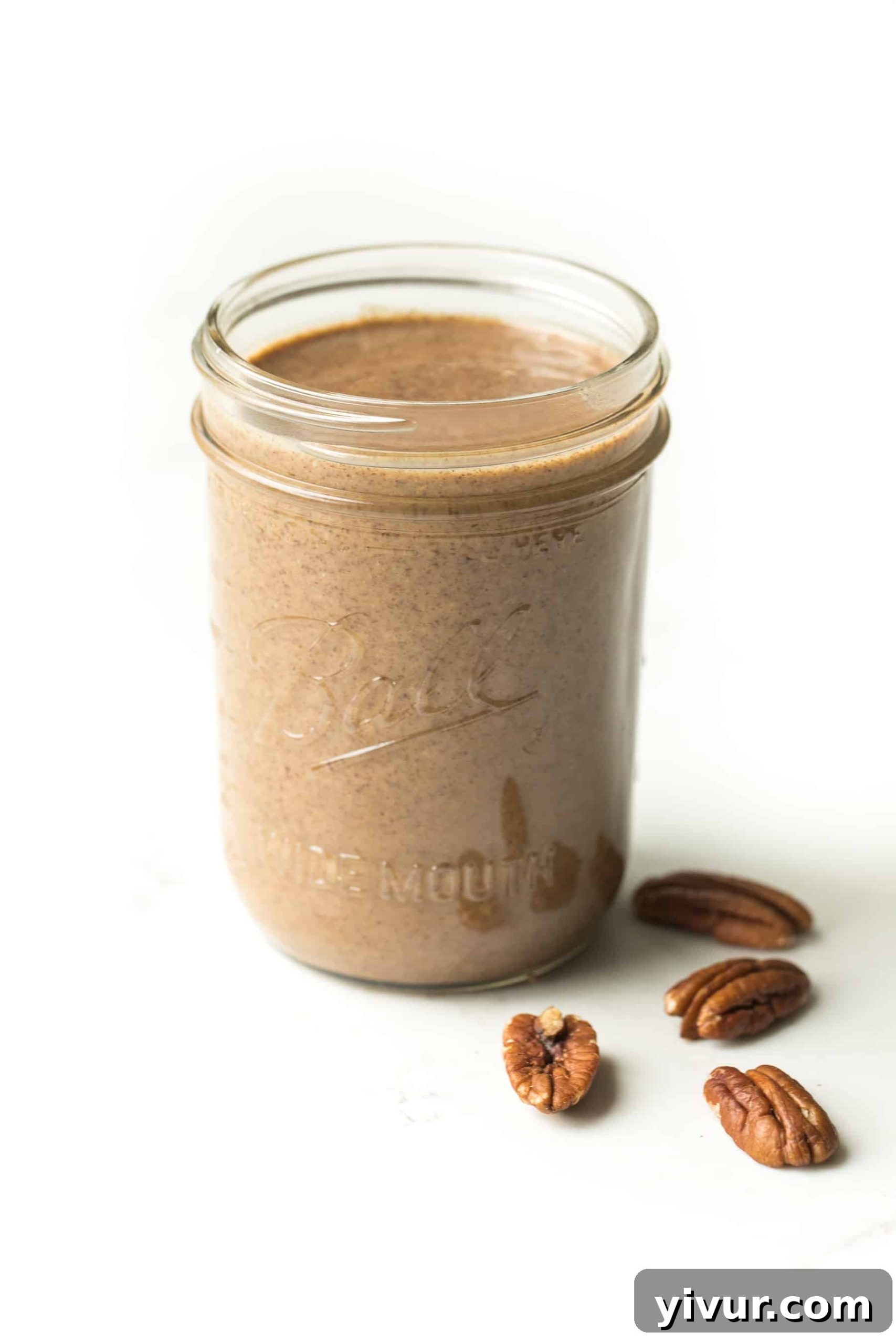 Creamy Paleo Whole30 Homemade Pecan Butter 5 A close-up shot of a mason jar filled with rich, homemade pecan butter, emphasizing its texture and appeal as a healthy, clean-eating snack.