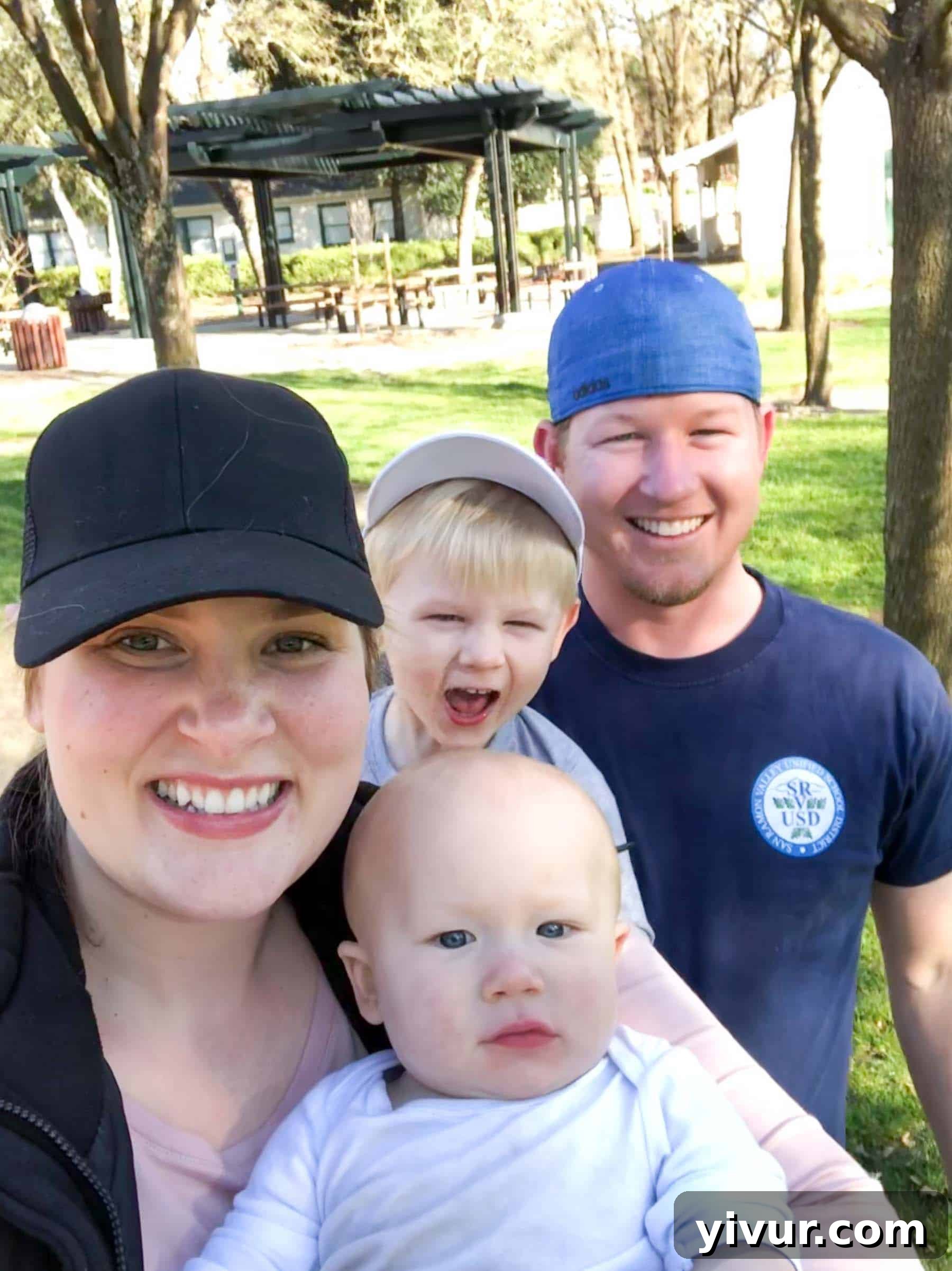 A vibrant family outing at the park: Children joyfully playing on swings and slides, while parents engage in conversation amidst the beauty of an approaching spring day, highlighting active family life.