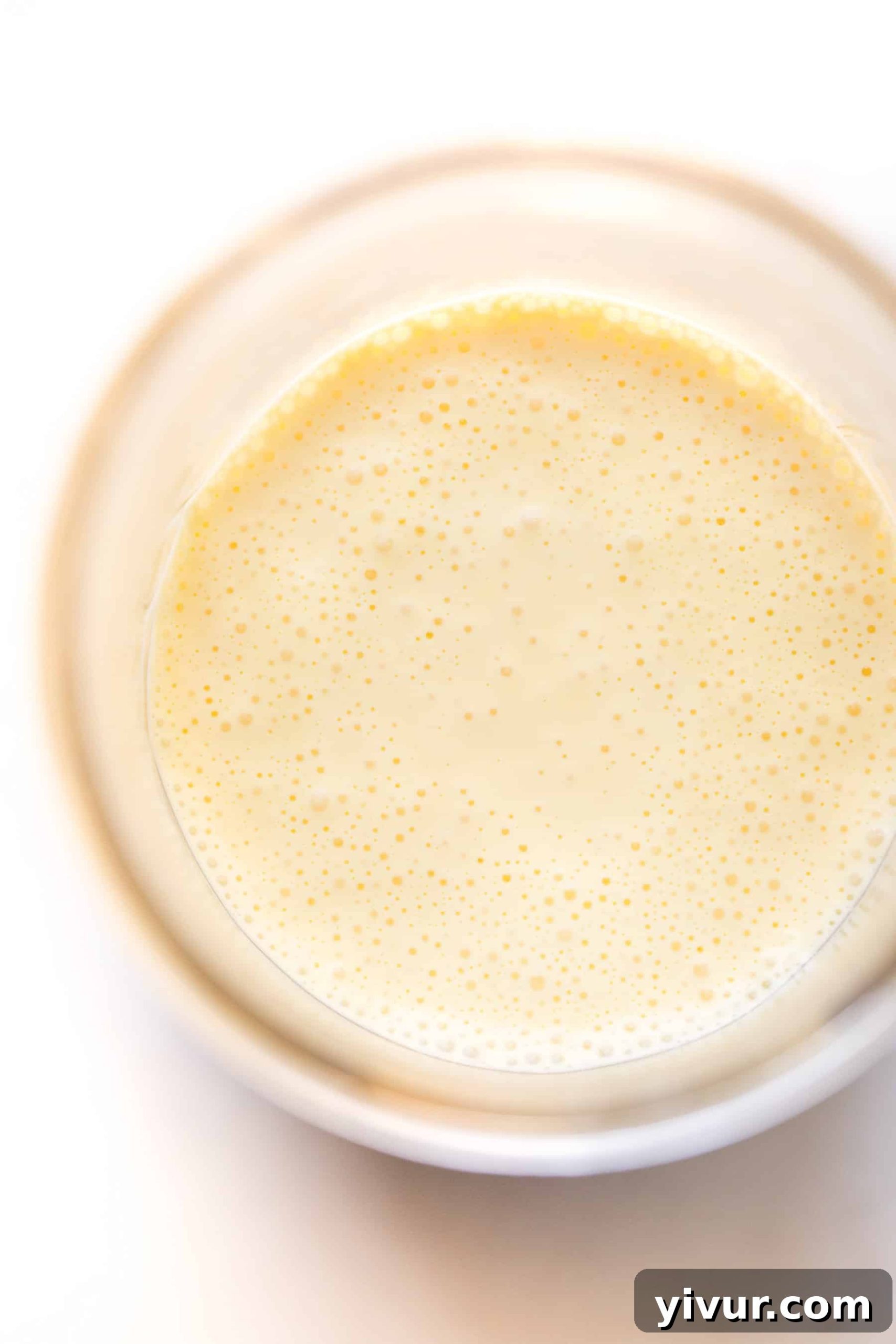 No-Fail Whole30 Hollandaise Sauce Paleo Keto Approved 3 Close-up shot of creamy hollandaise sauce in a mason jar, ready to be served