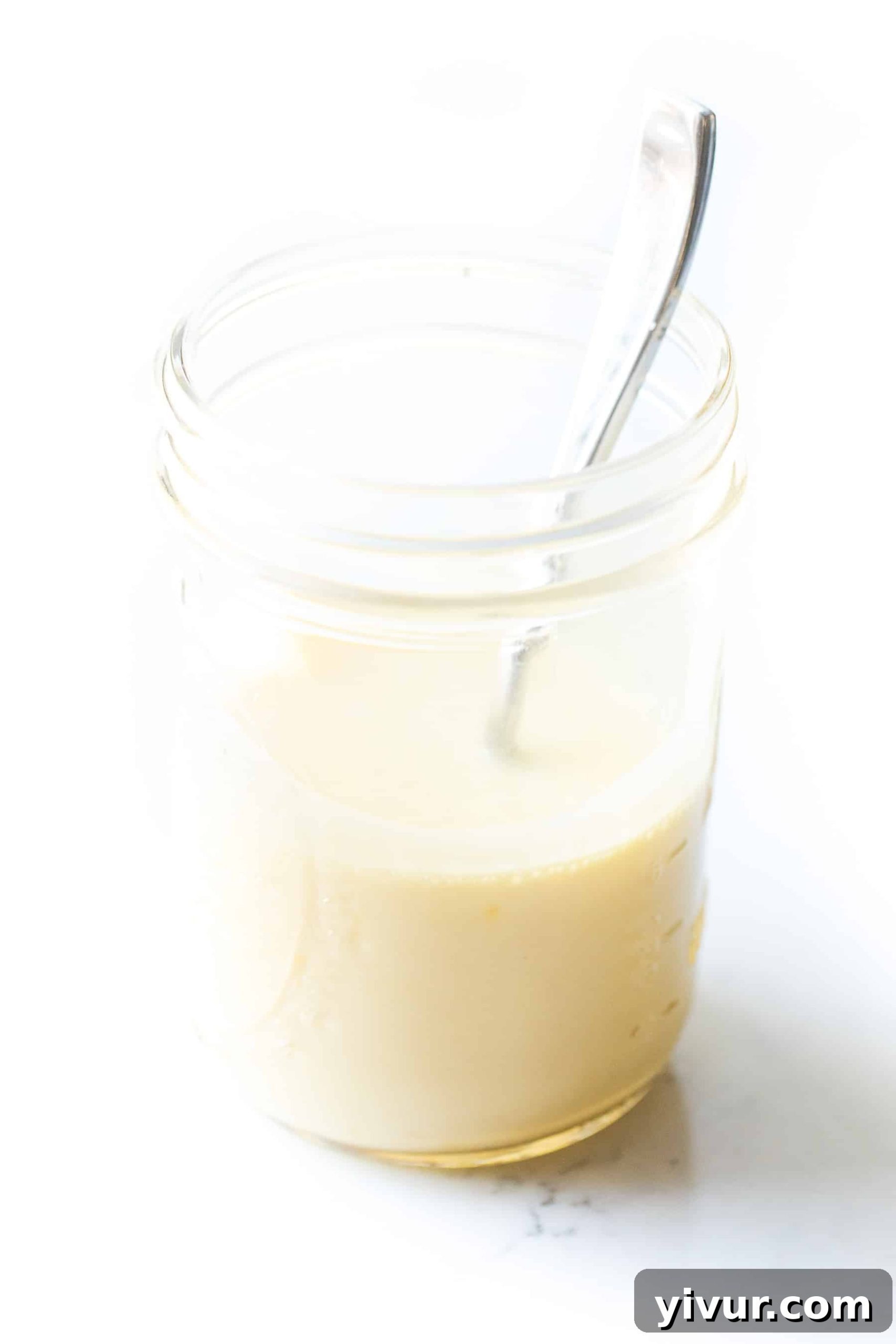 No-Fail Whole30 Hollandaise Sauce Paleo Keto Approved 6 Hollandaise sauce in a mason jar with a spoon, showing its creamy texture