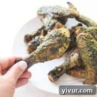 Zesty Grilled Chimichurri Chicken: Whole30, Keto & Paleo 7 Crispy grilled chicken drumsticks and wings with vibrant green chimichurri sauce.