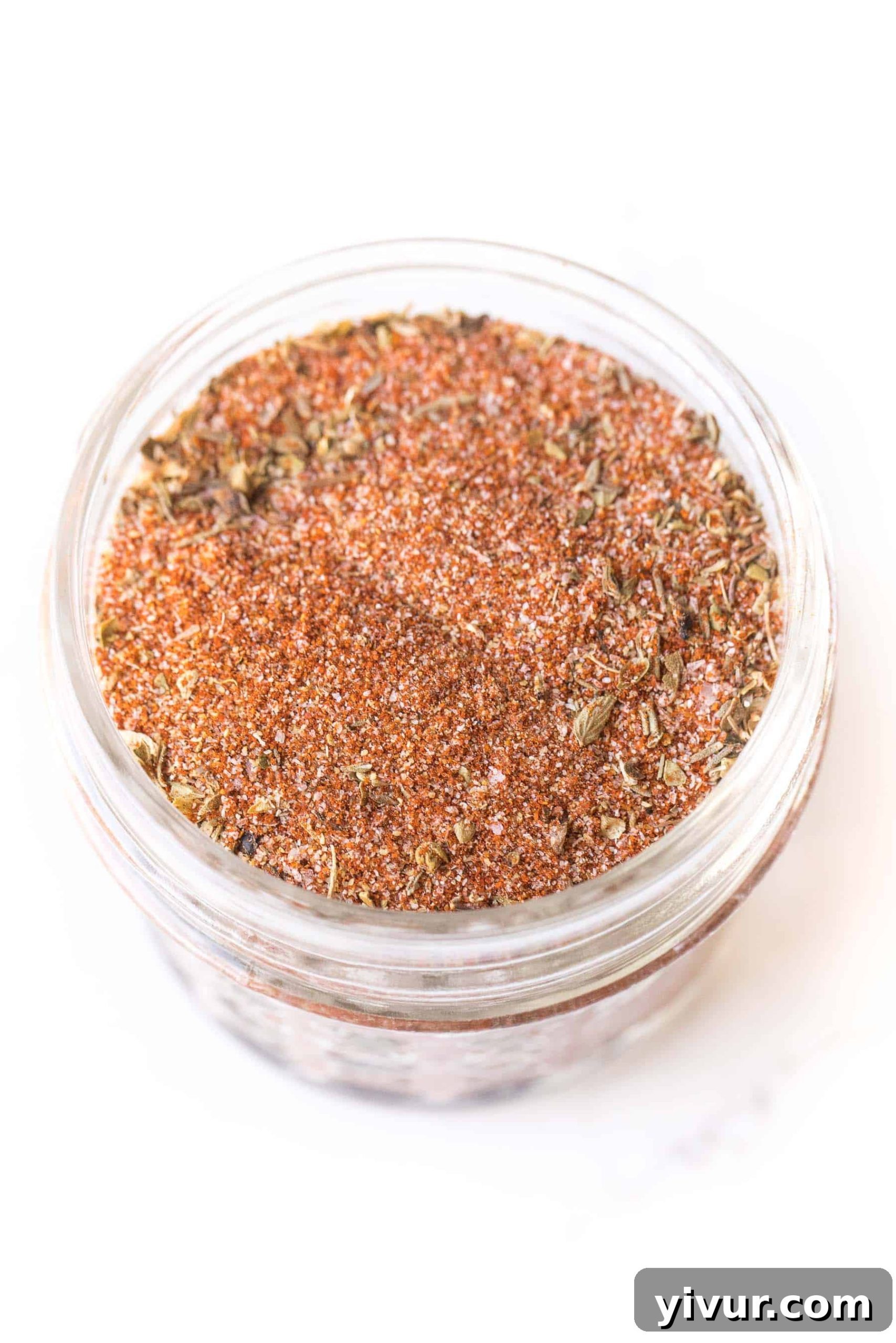cajun seasoning in a small mason jar on a white background