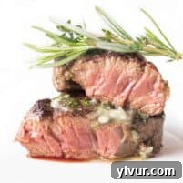 Beautifully plated filet mignon with herb butter, ready to serve.