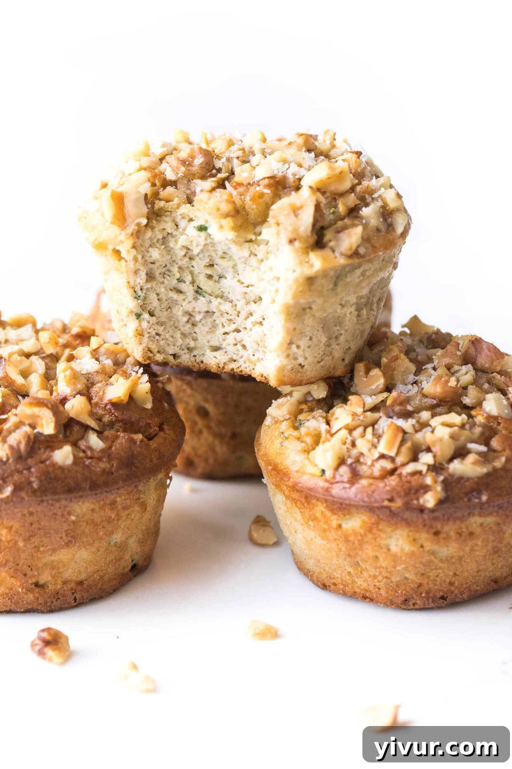 stack of paleo zucchini muffins on a white background