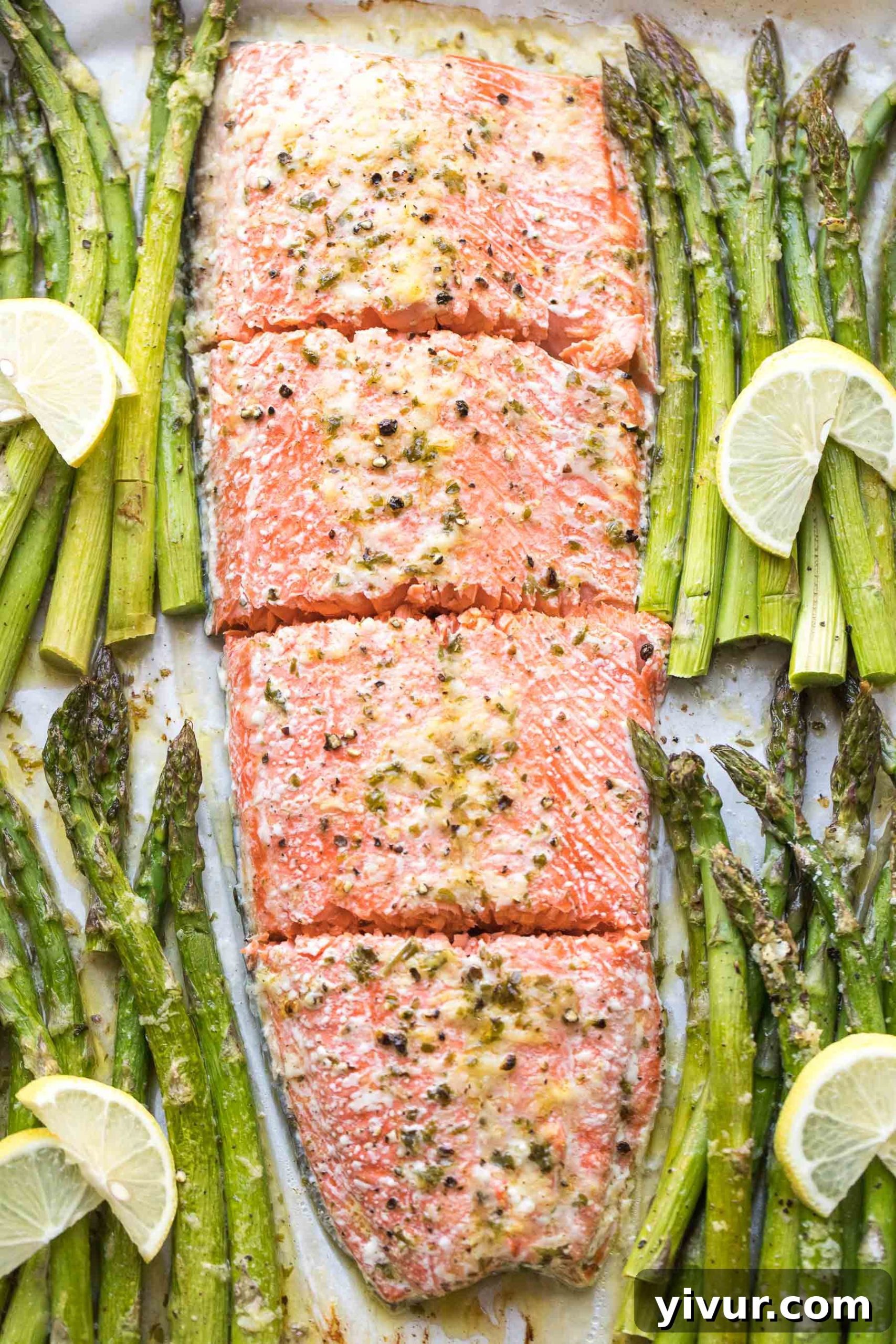 Close-up of roasted salmon and asparagus on a sheet pan, fresh from the oven