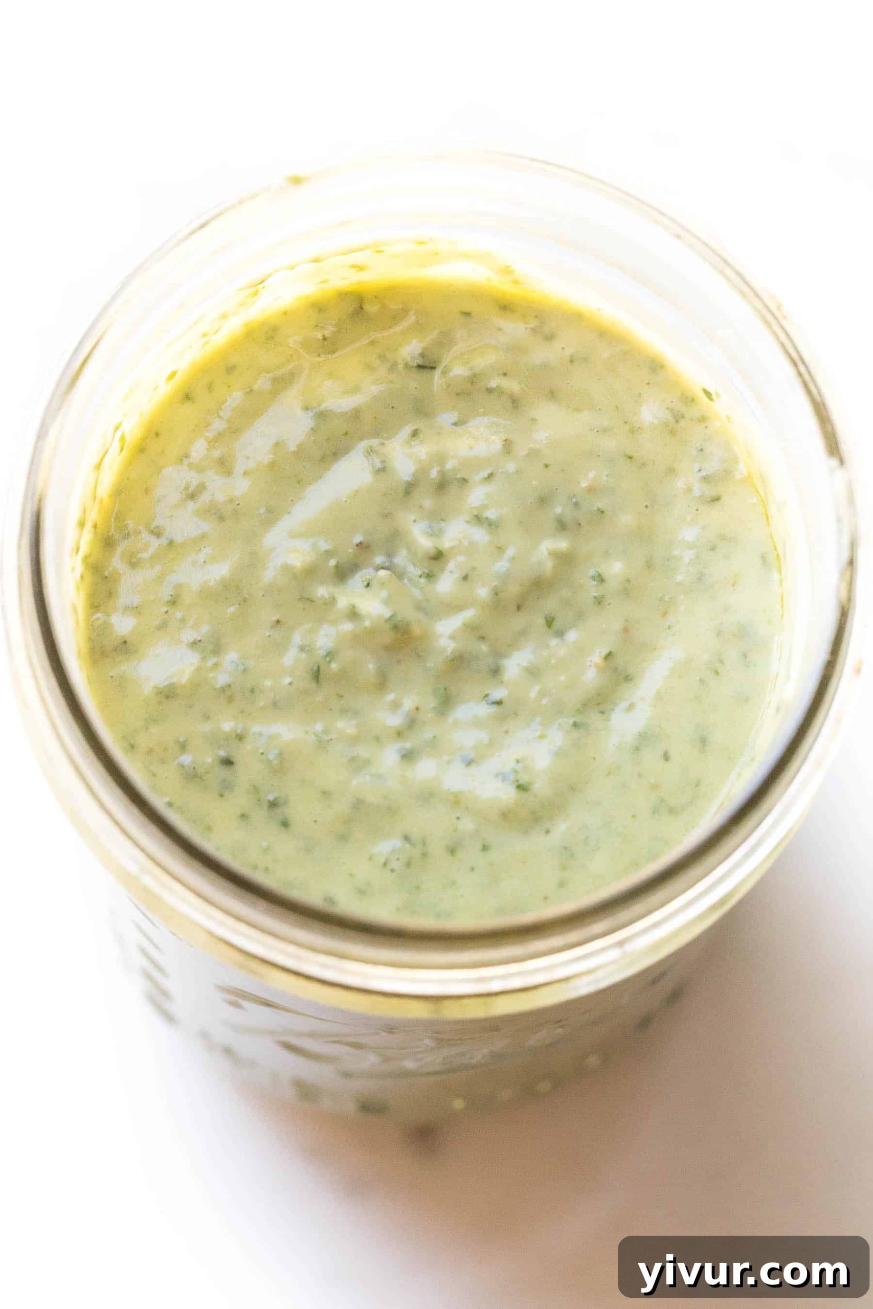 Flavorful Keto Whole30 Pesto Aioli 4 pesto aioli in a mason jar on a white background