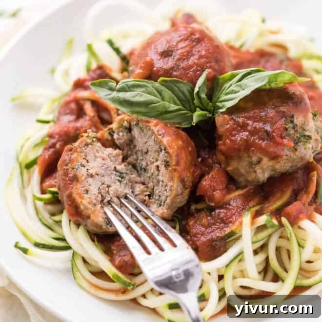 A fork cutting into a meatball made without breadcrumbs