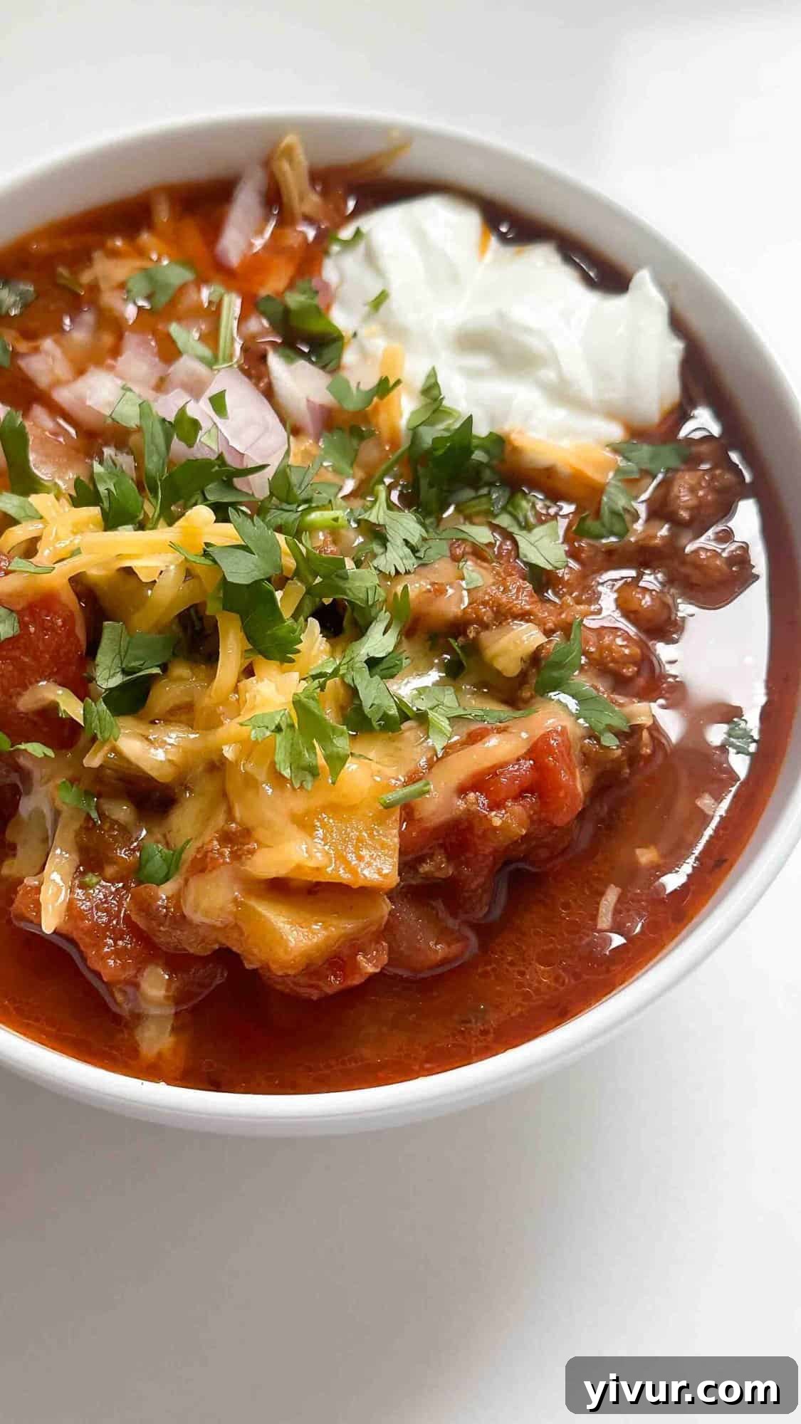 Keto Whole30 Instant Pot Chili Beanless and Easy 8 A comforting bowl of Whole30 keto chili, beautifully garnished with fresh avocado slices and cilantro, ready to be enjoyed.
