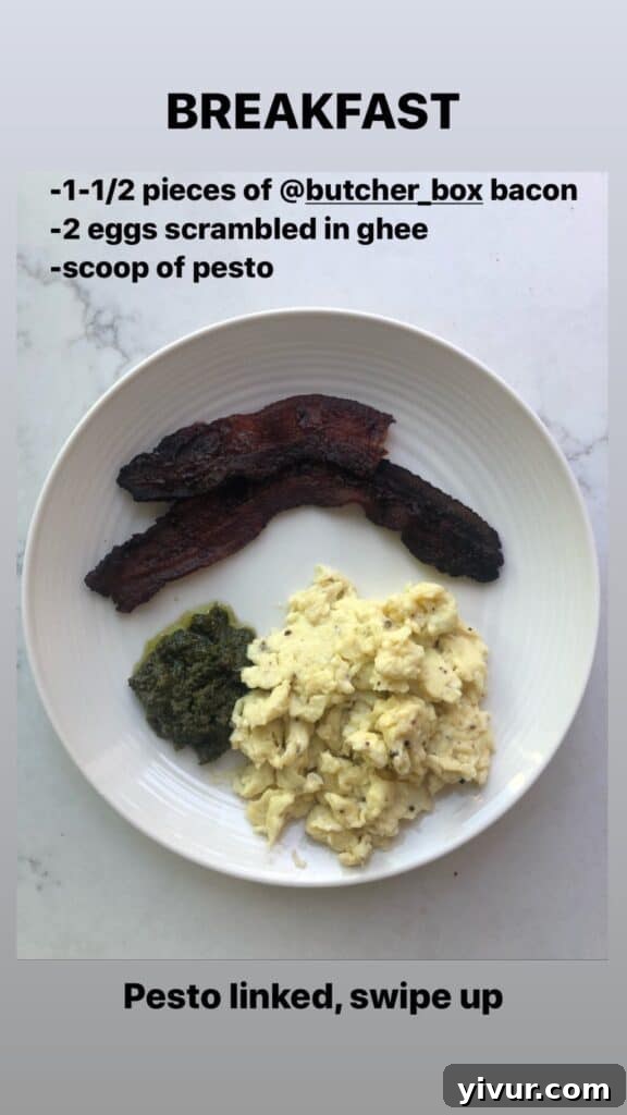 A plate of grilled chicken with vibrant green pesto and fresh vegetables, showcasing a delicious clean keto and Whole30 meal.