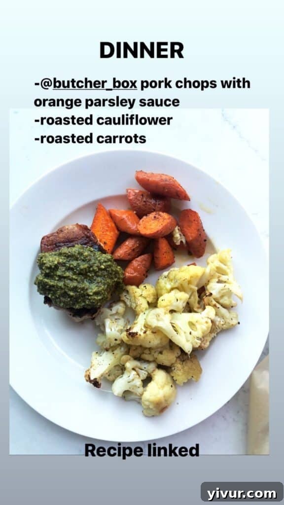 Pork Chops with Orange Parsley Sauce, served with roasted carrots and roasted cauliflower, a delicious Whole30 and keto meal.