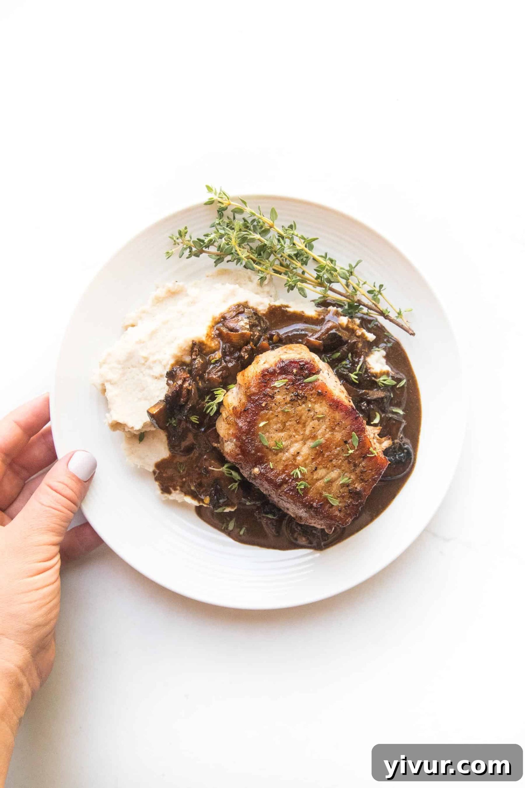 Ultimate Whole30 Keto Pork Chops with Creamy Bacon Mushroom Sauce 4 A healthy and comforting Whole30 Keto dinner: thick-cut pork chops and a hearty bacon mushroom sauce, plated with a side of fluffy cauliflower mash.