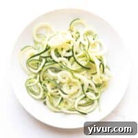 Flavorful Whole30 Keto Zucchini Noodles 4 A vibrant bowl of Whole30 and Keto zucchini noodles, garnished and ready for a delicious meal.