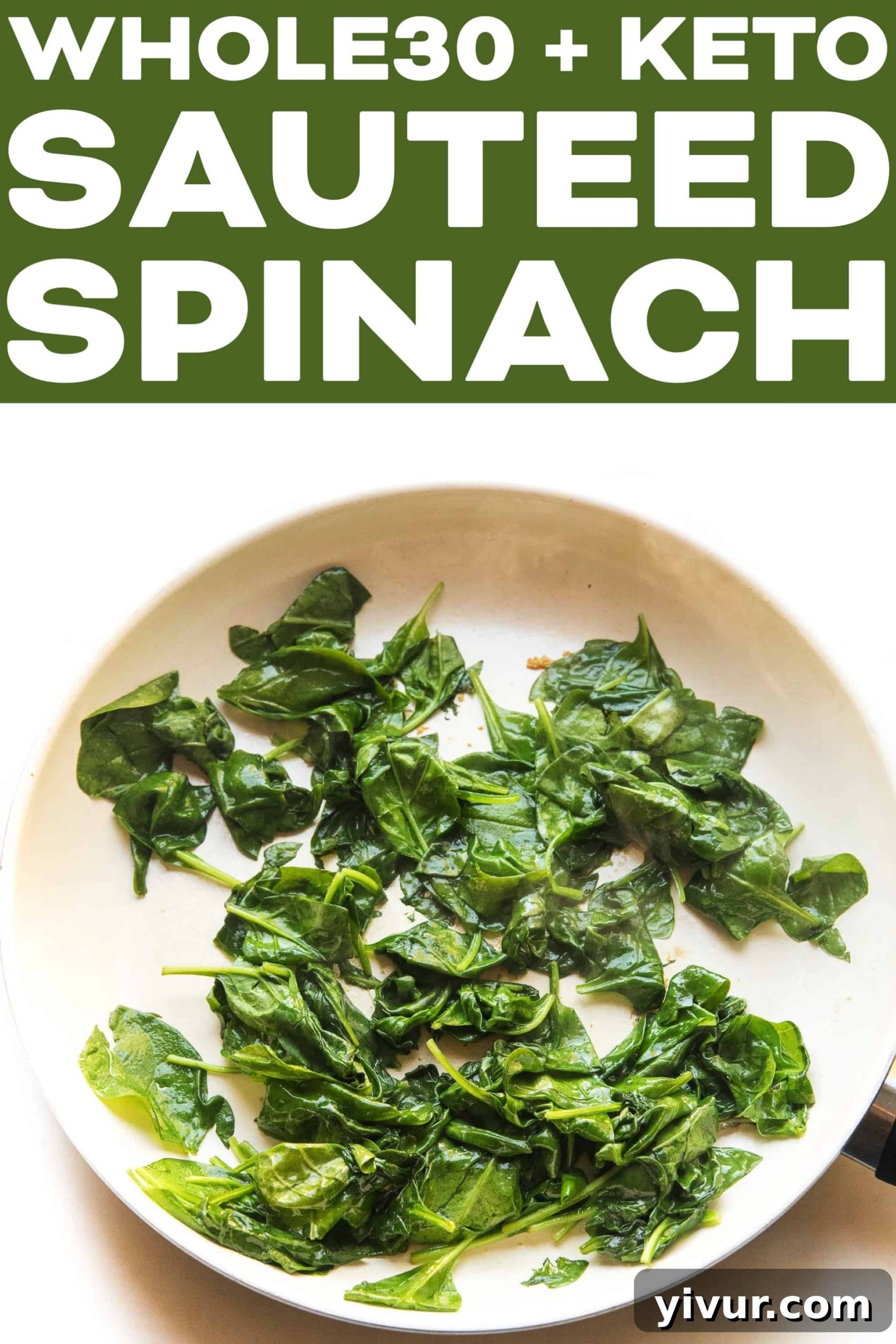 A close-up of perfectly sautéed spinach in a white skillet, garnished and ready.