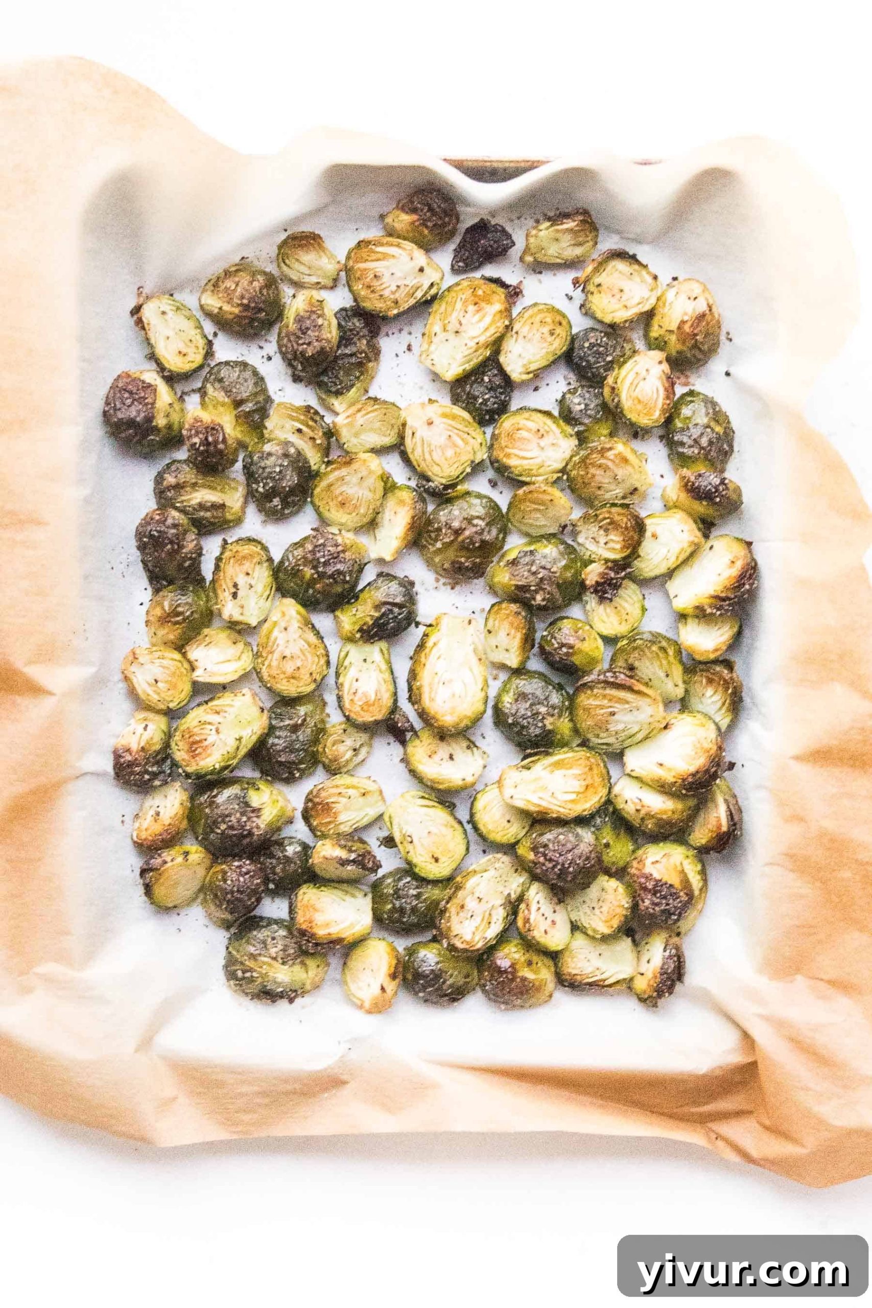Golden brown roasted Brussels sprouts on a baking sheet, ready to serve