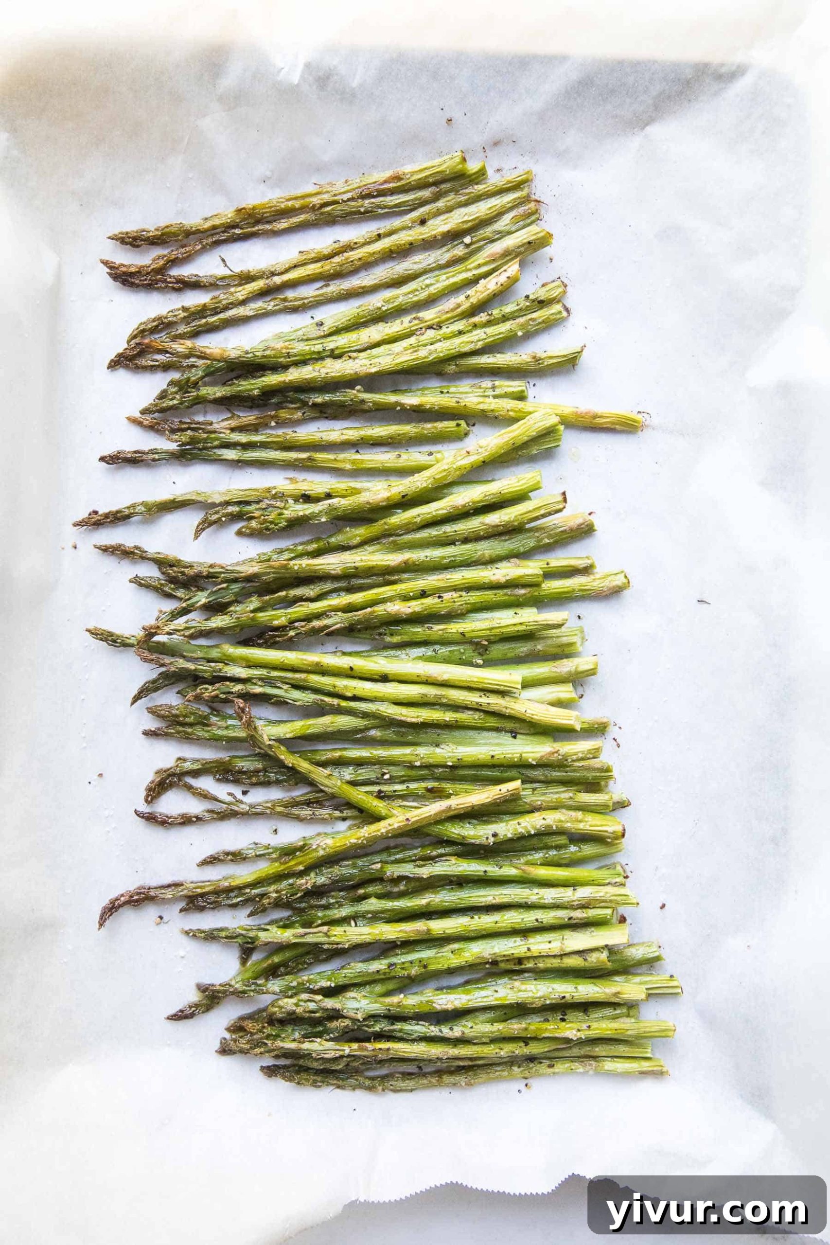 Perfectly roasted asparagus on a rimmed baking sheet, golden and crisp