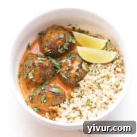 Keto Thai Curry Meatballs with creamy sauce and fresh garnishes.