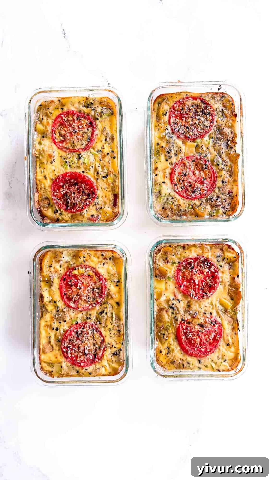 High-Protein Ham, Egg & Potato Meal Prep Bowls for Busy Days 6 Four rectangular glass meal prep bowls filled with a high protein ham egg potato casserole, each topped with slices of tomato and sprinkled herbs, arranged on a white surface.
